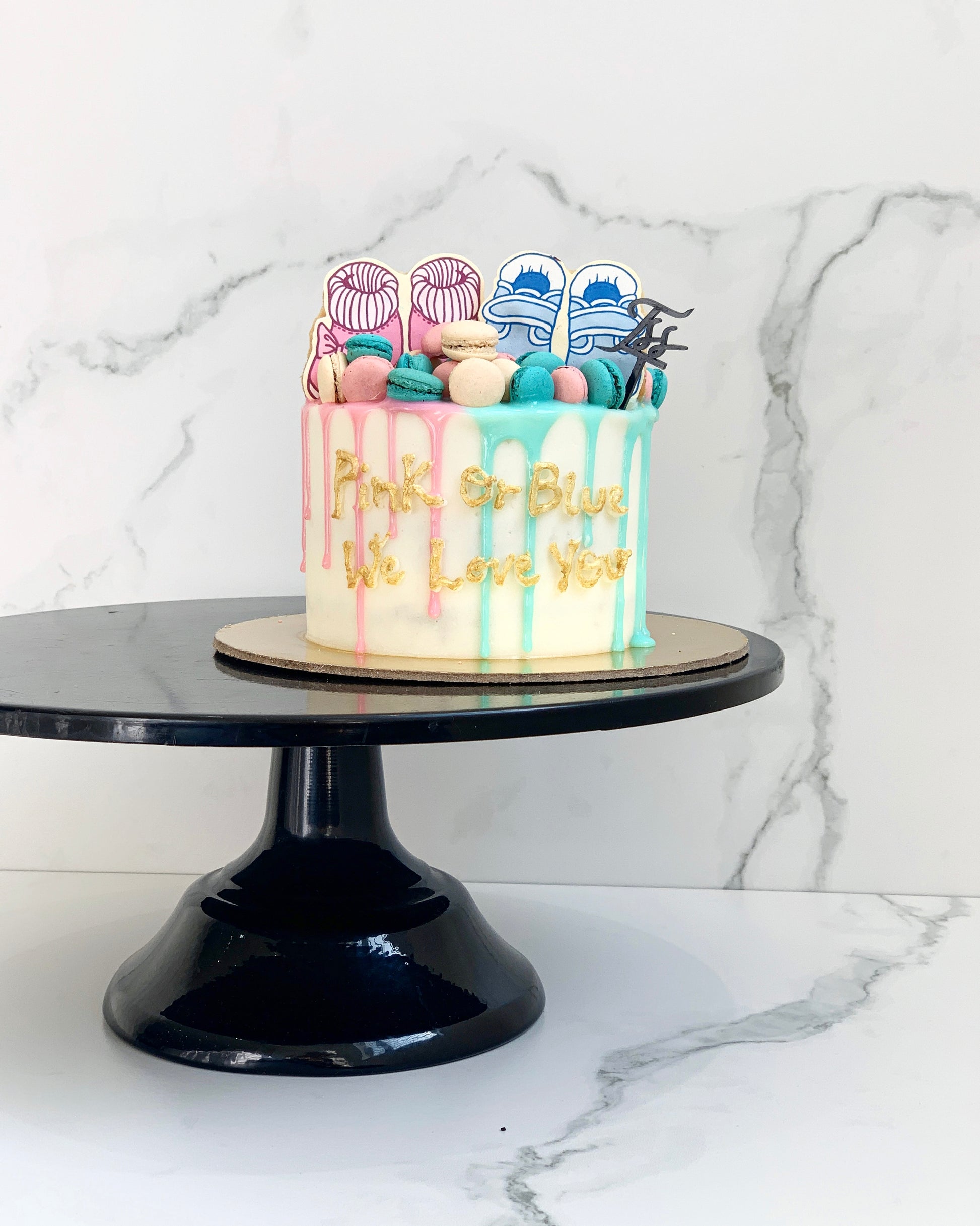 Decorative baby shower cake from The Sinful Spoon with pastel colors and cute baby-themed decorations.