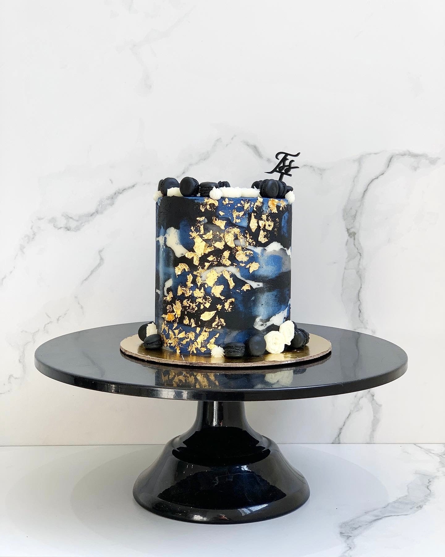 Image of a classic cake from The Sinful Spoon, showcasing a layered dessert with frosting and decorative toppings.