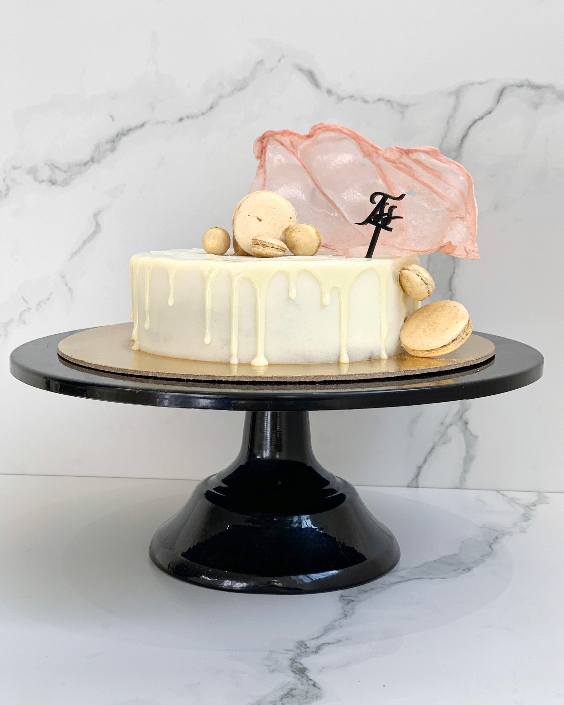 A selection of classic cakes from The Sinful Spoon, featuring layered chocolate, vanilla, and fruit-flavored desserts on a white plate.