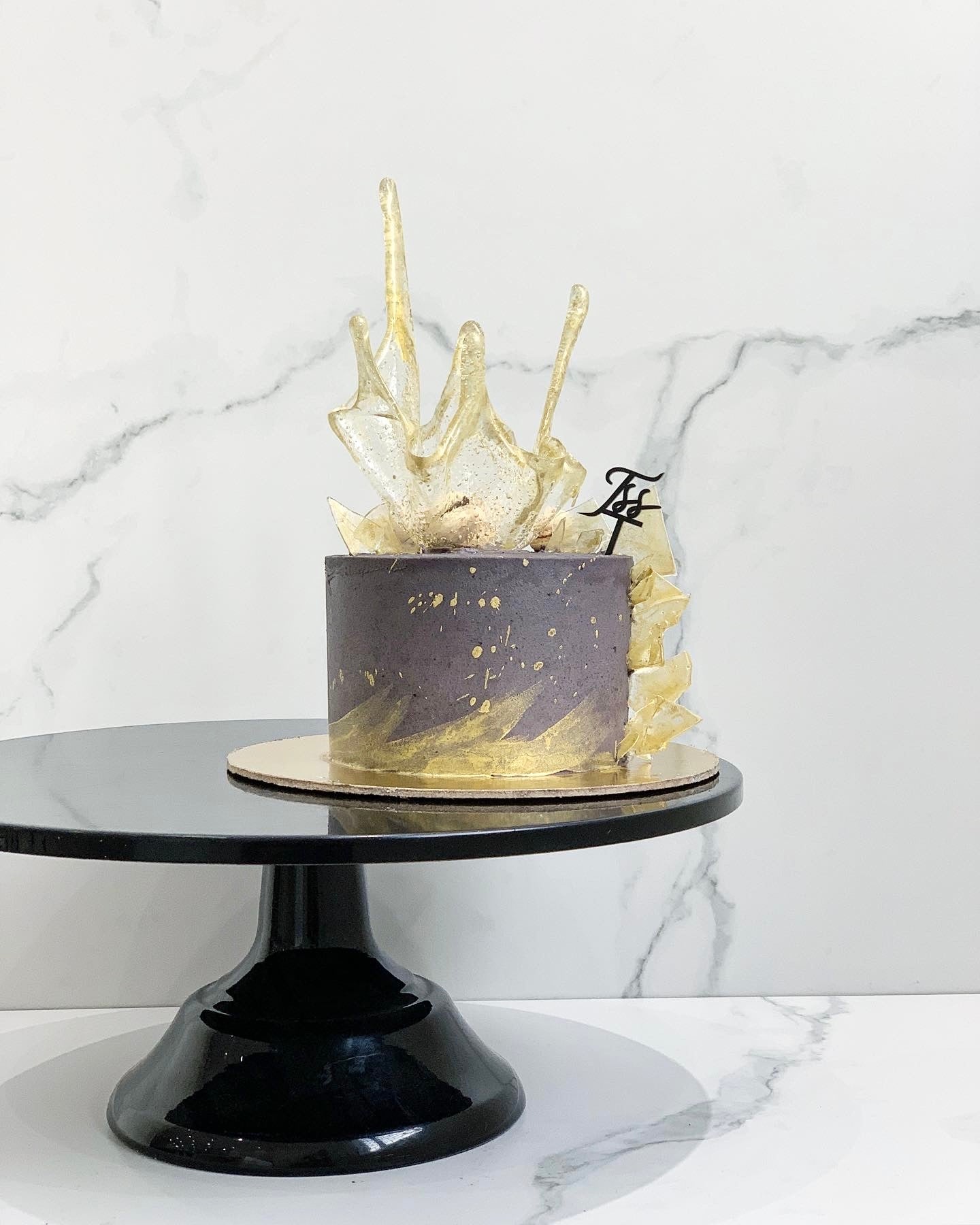 Colorful Isomalt Cakes from The Sinful Spoon, showcasing vibrant, glossy sugar confectionery in various shapes and shades.