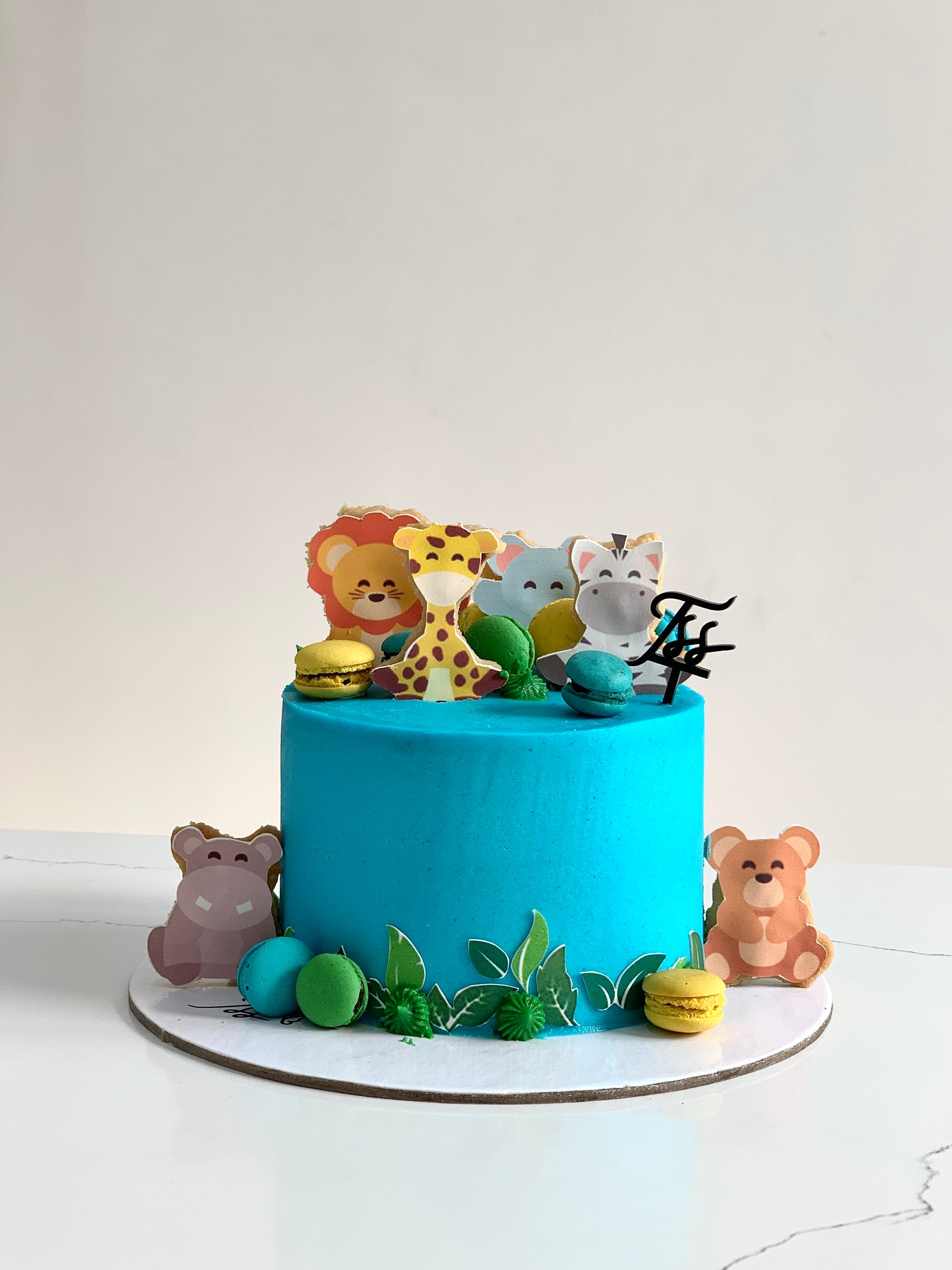 Edible paper cake topper featuring a baby boy design from The Sinful Spoon, perfect for baby shower desserts.