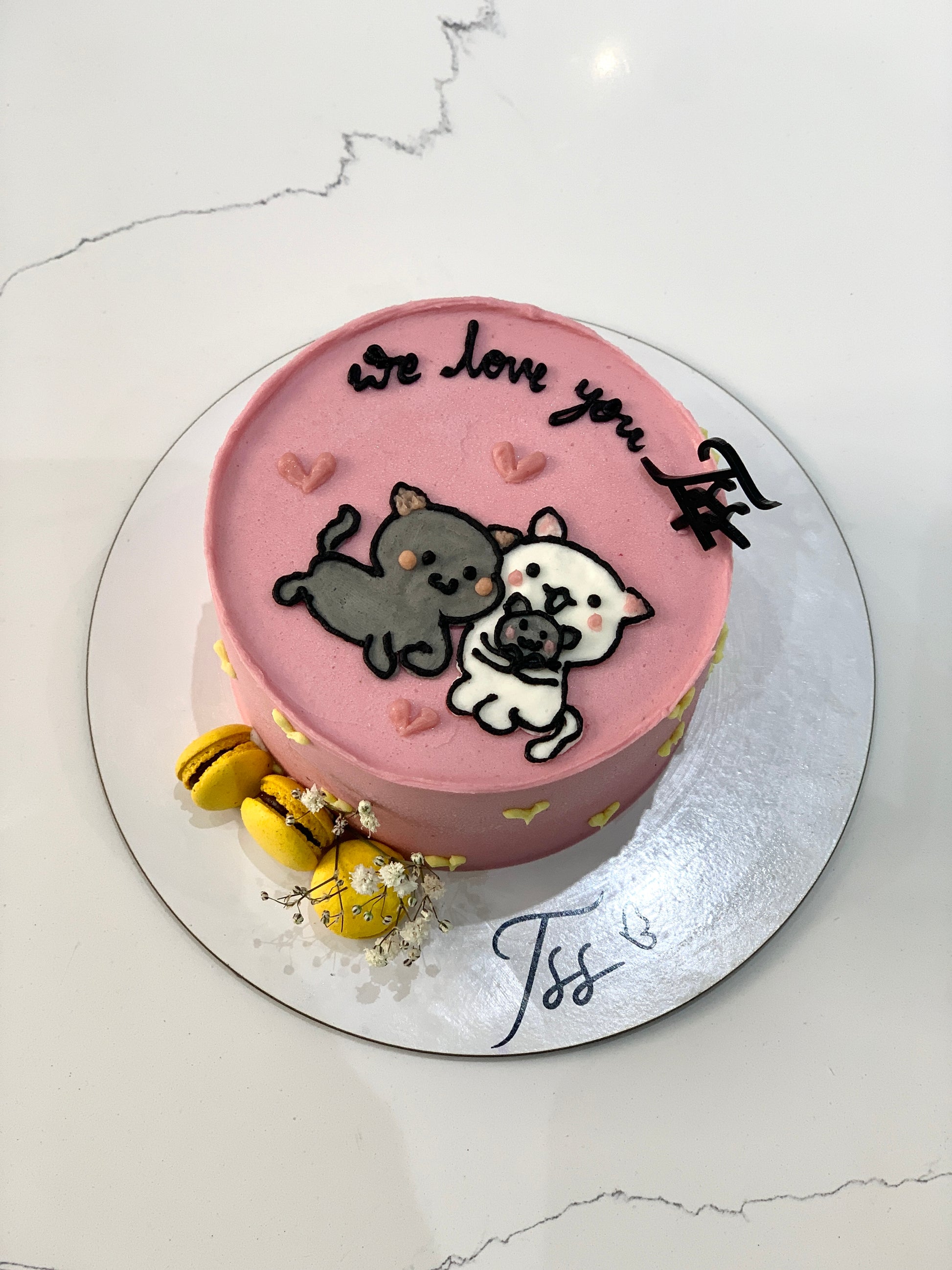 Valentine's Day cake from The Sinful Spoon featuring pink frosting, heart-shaped decorations, and festive Valentine's Day design.