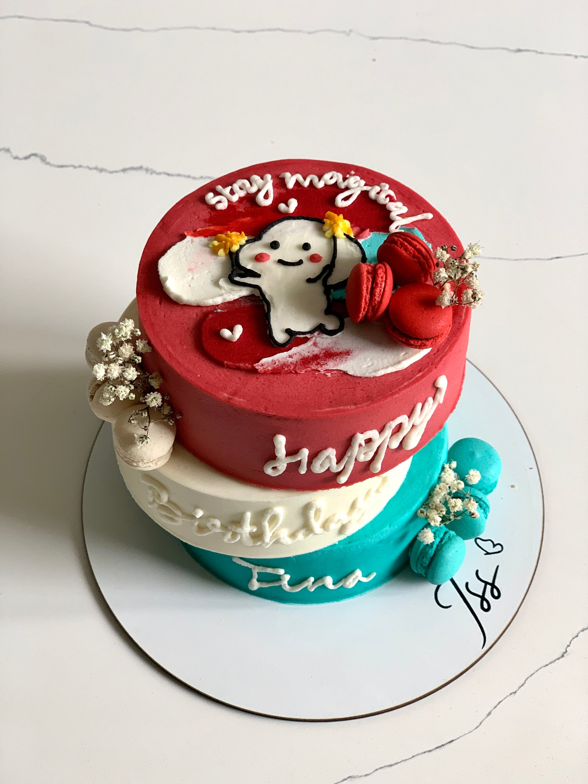 Asymmetrical cakes from The Sinful Spoon with layered frosting and decorative toppings on a white plate.
