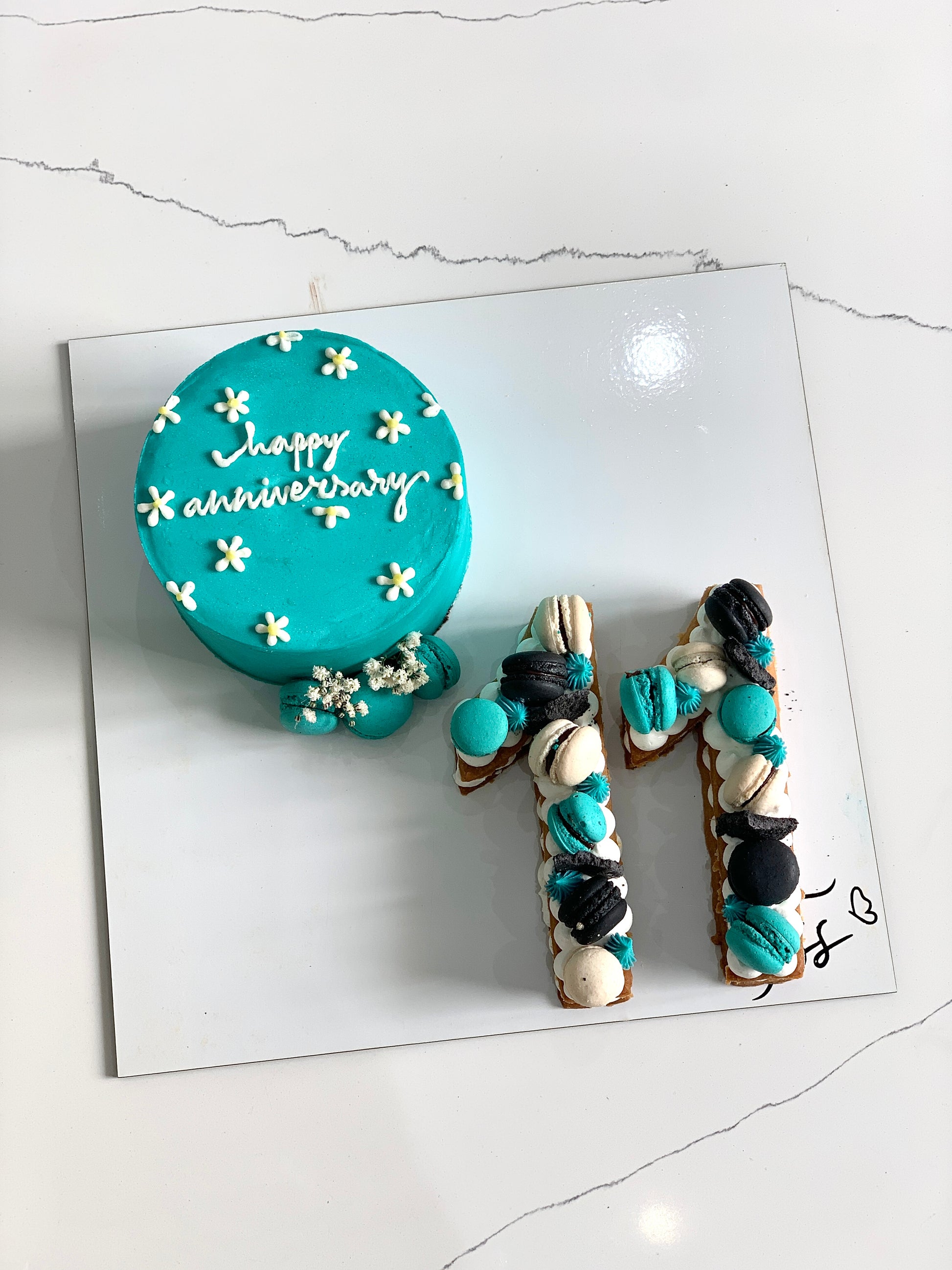 Assorted combo cakes from The Sinful Spoon with colorful frosting and decorative toppings on a white plate.