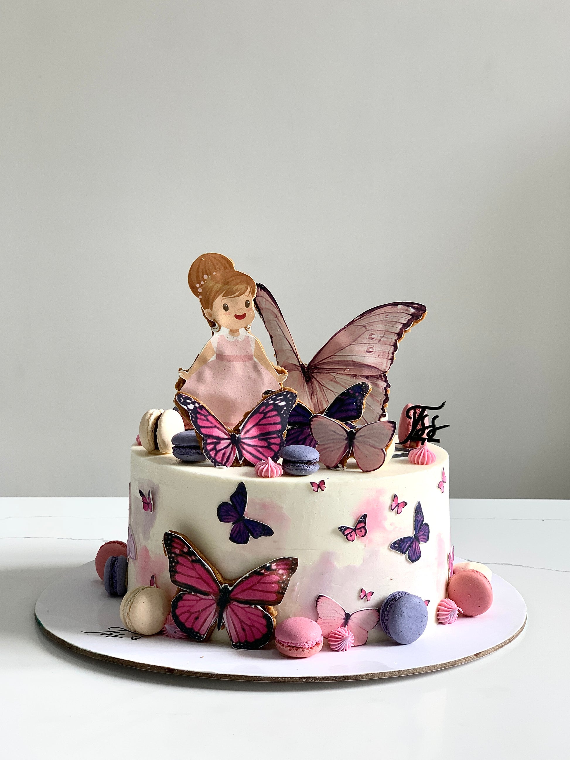 Edible paper cake topper featuring a baby girl design from The Sinful Spoon, perfect for baby shower desserts.
