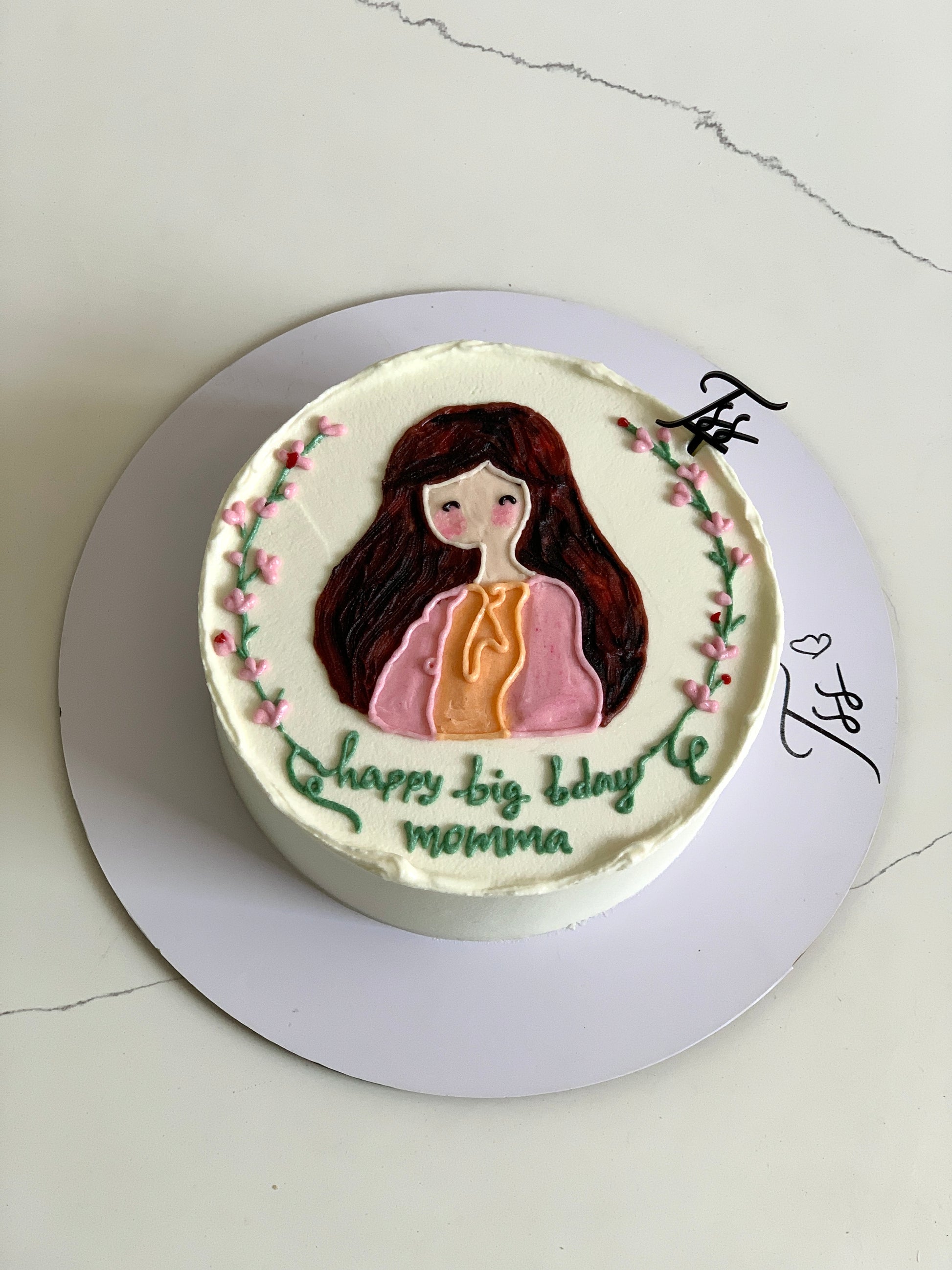 Colorful buttercream illustration cake by The Sinful Spoon with vibrant floral and whimsical design, detailed icing decorations.