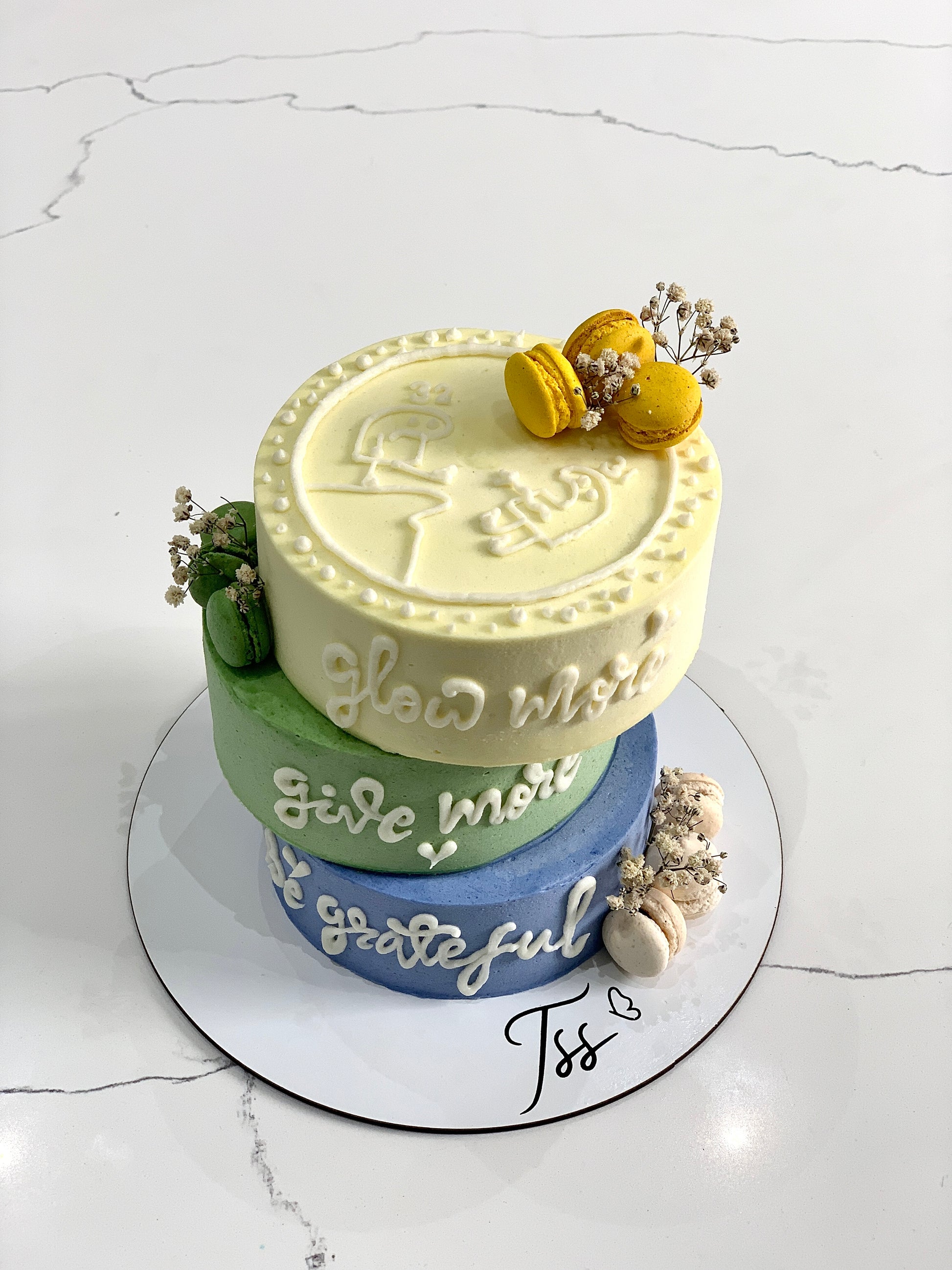 Asymmetrical cakes from The Sinful Spoon, decorated with vibrant icing and creative design on a white plate.