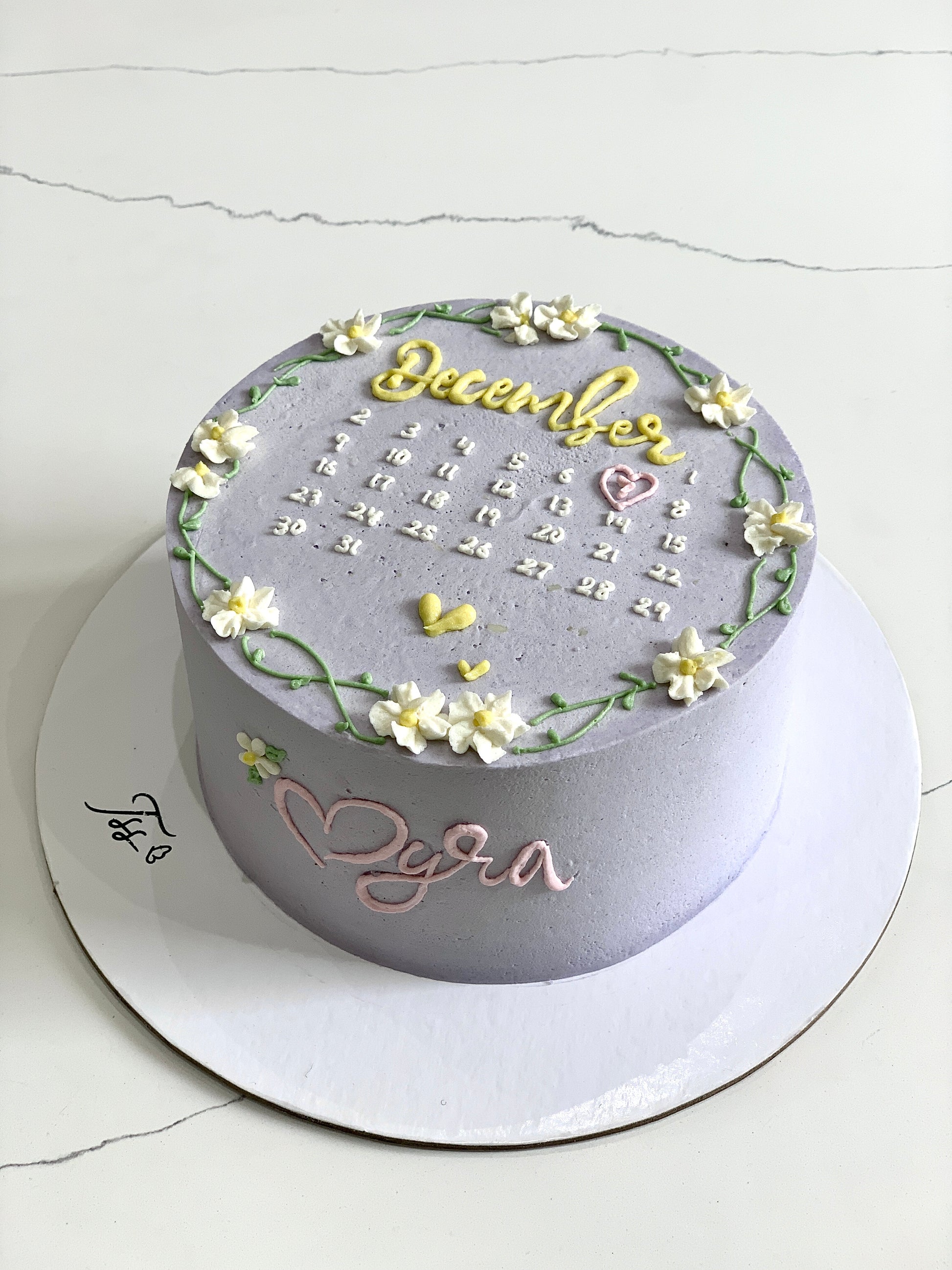 Decorative buttercream flower cakes by The Sinful Spoon, featuring colorful floral designs on a cake.