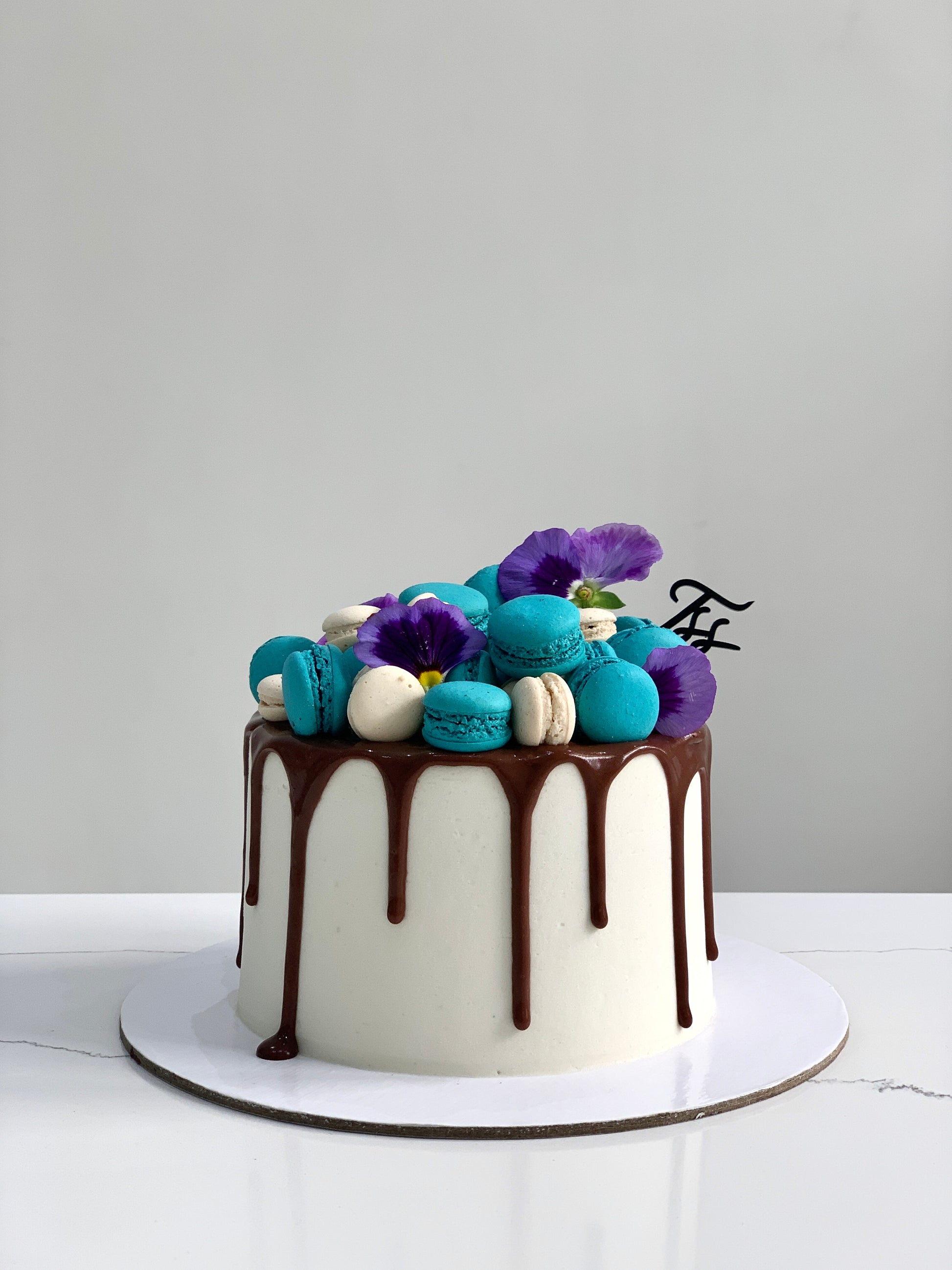 Classic cakes from The Sinful Spoon displayed on a plate with decorative elements, showcasing their rich textures and frosting details.