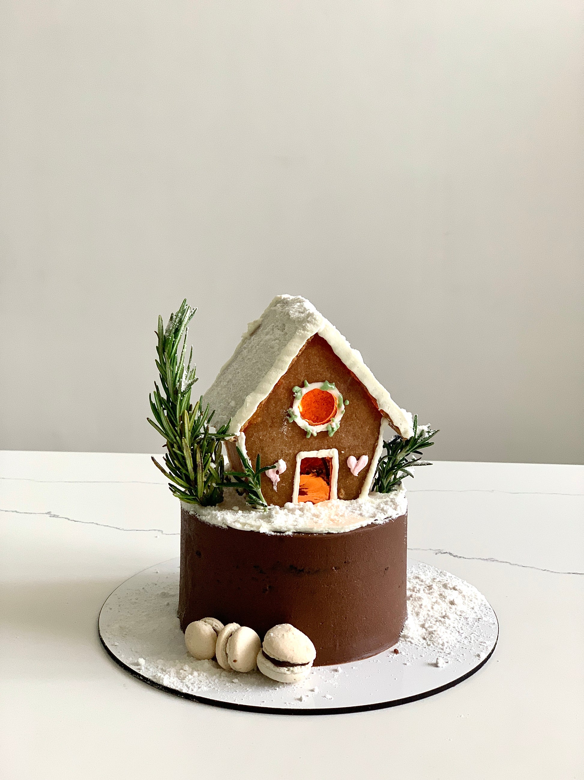 Decorative Christmas cake from The Sinful Spoon with festive icing and holiday-themed decorations on a plate.