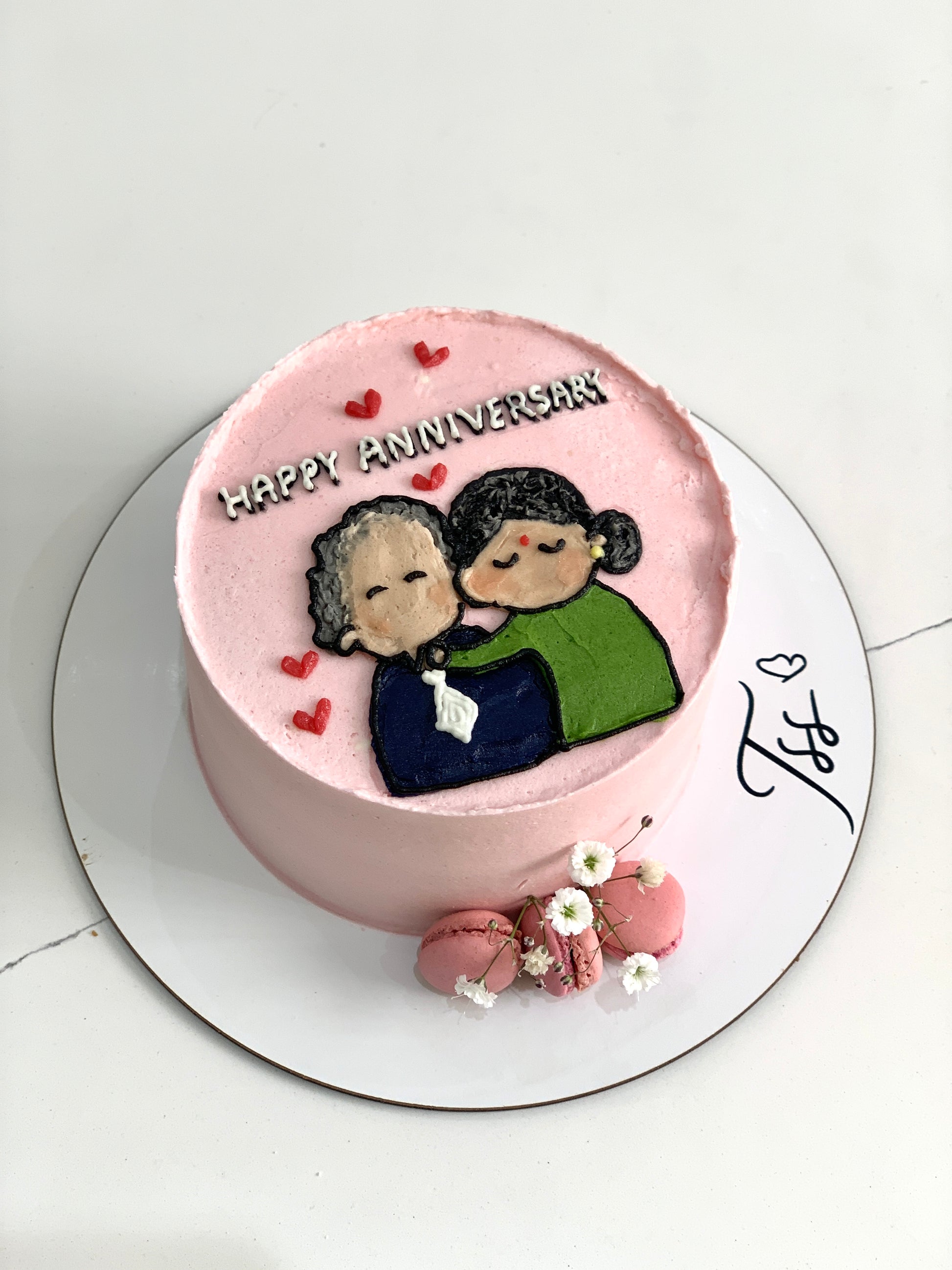 Valentine's Day cake from The Sinful Spoon with pink frosting, heart-shaped decorations, and romantic themed design on top.