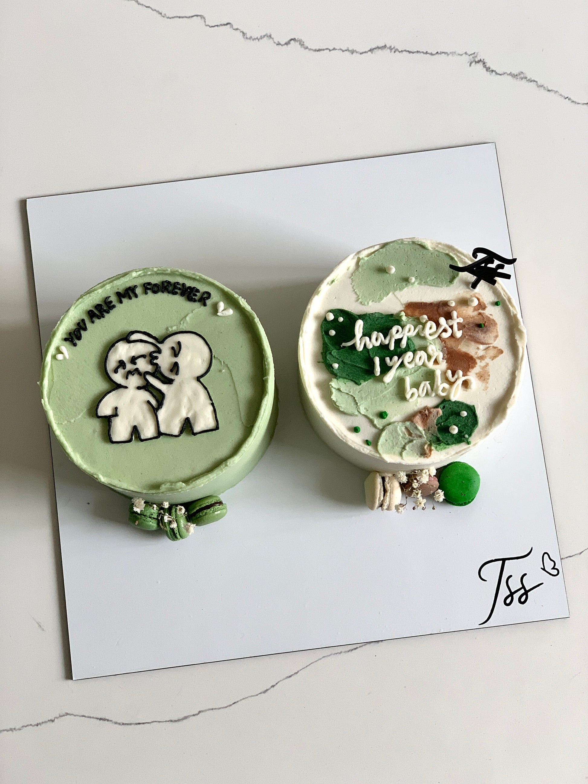 Assorted combo cakes from The Sinful Spoon featuring colorful frosting and varied layers, displayed on a plate.