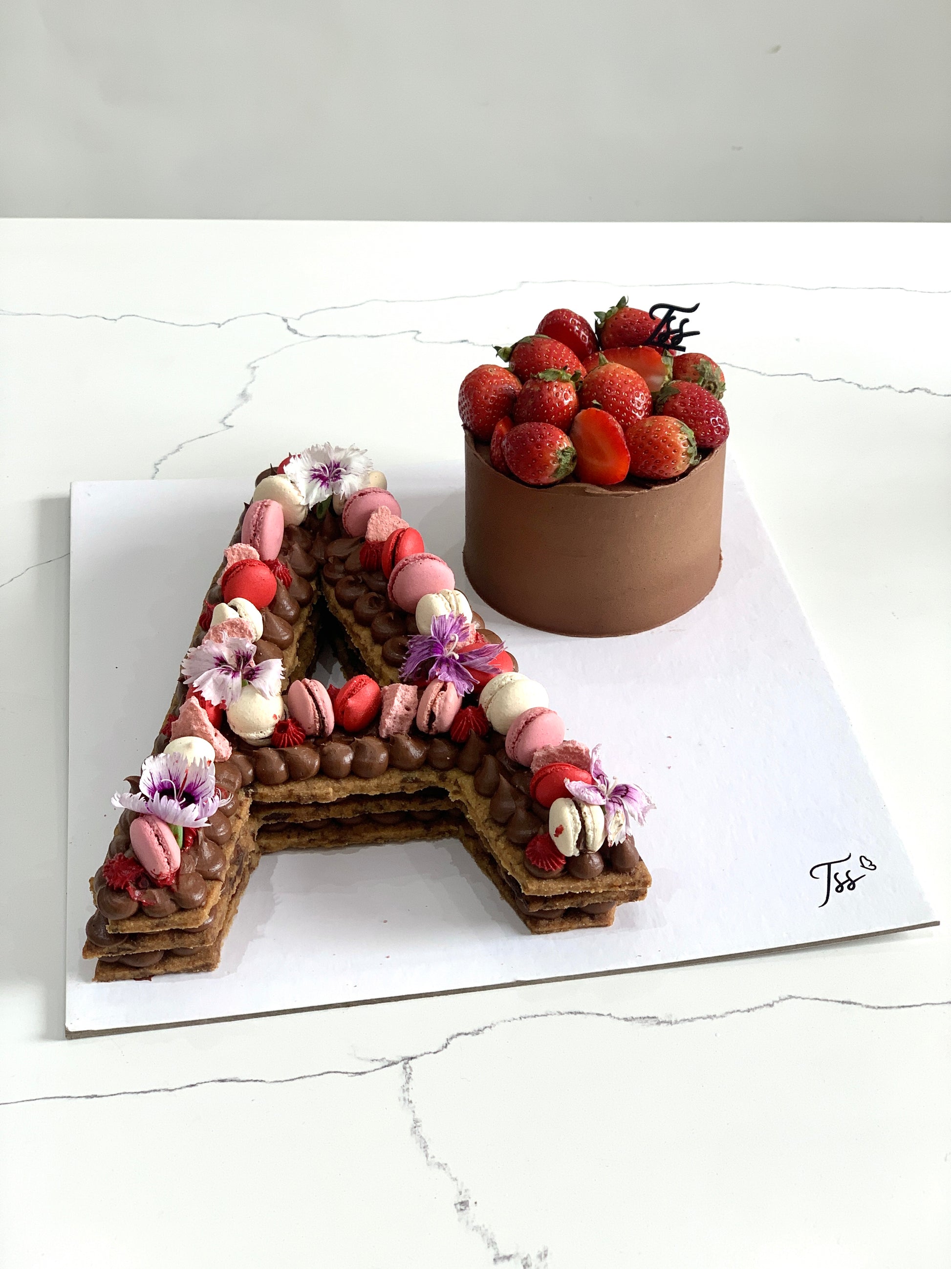 Assorted combo cakes from The Sinful Spoon, featuring layered and decorated desserts on a serving platter.