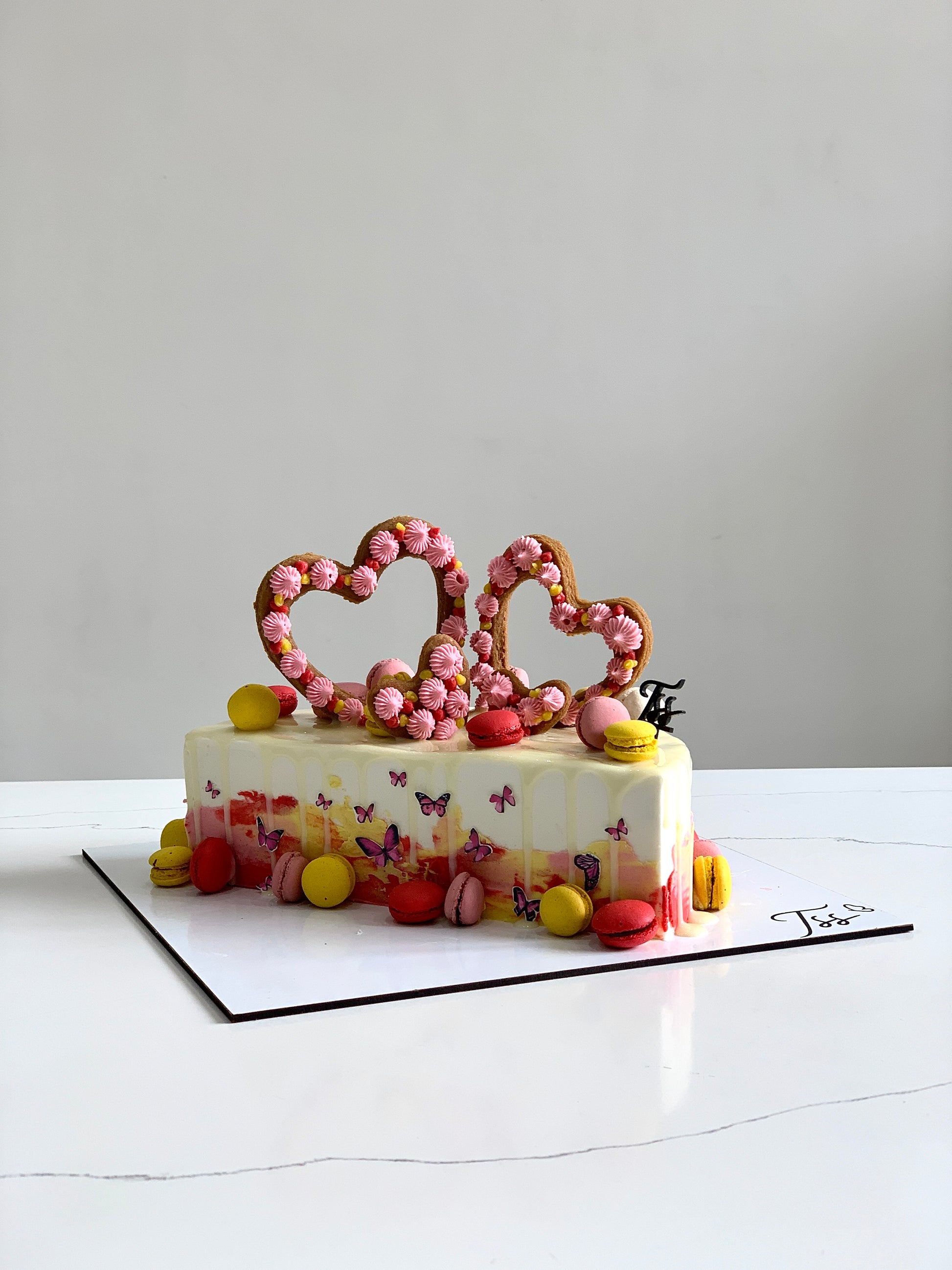 Half birthday cake from The Sinful Spoon with colorful frosting and decorative sprinkles on top.