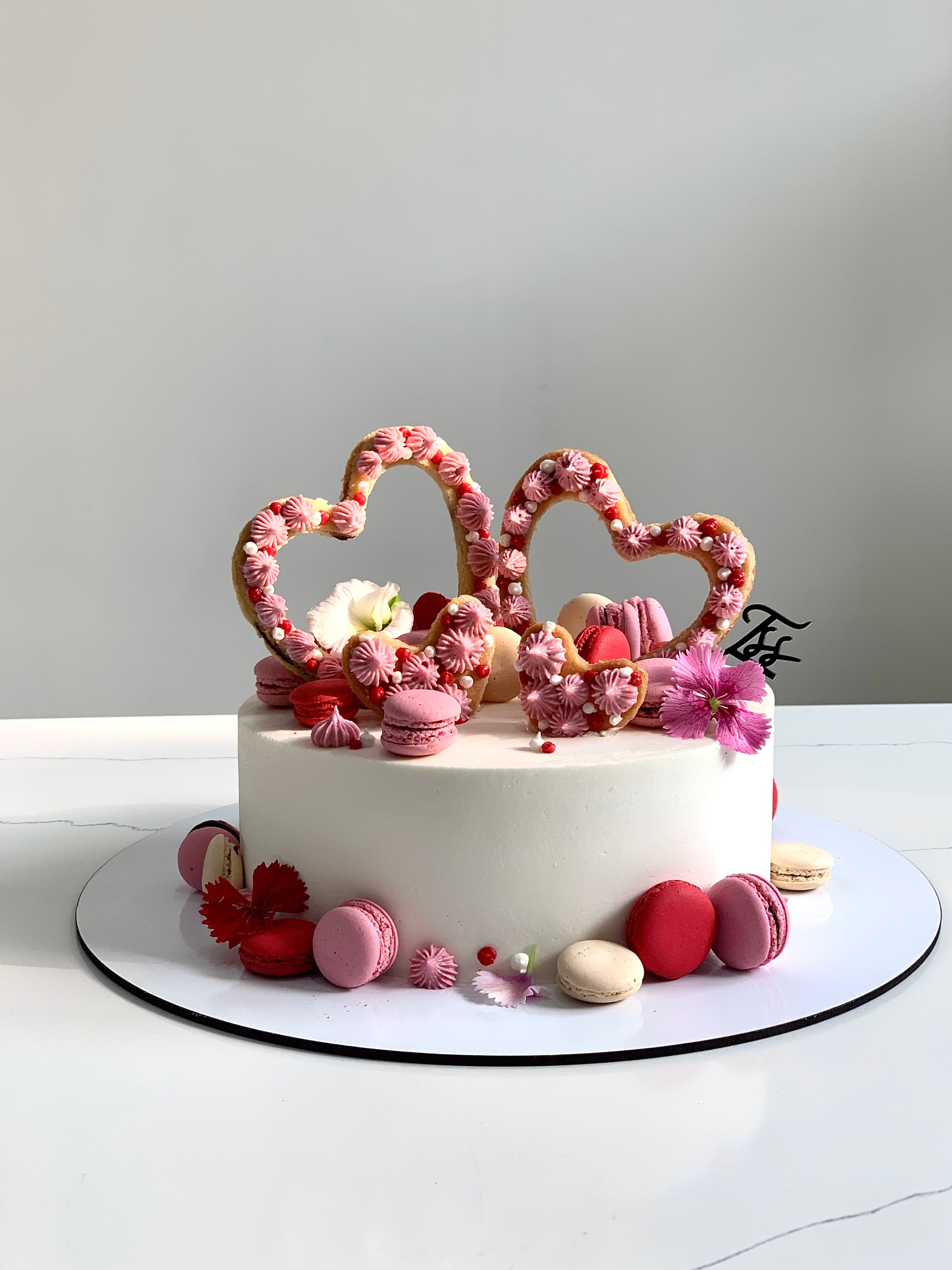Chocolate Valentine's Day cake from The Sinful Spoon with heart-shaped decoration and rich frosting, perfect for romantic celebrations.