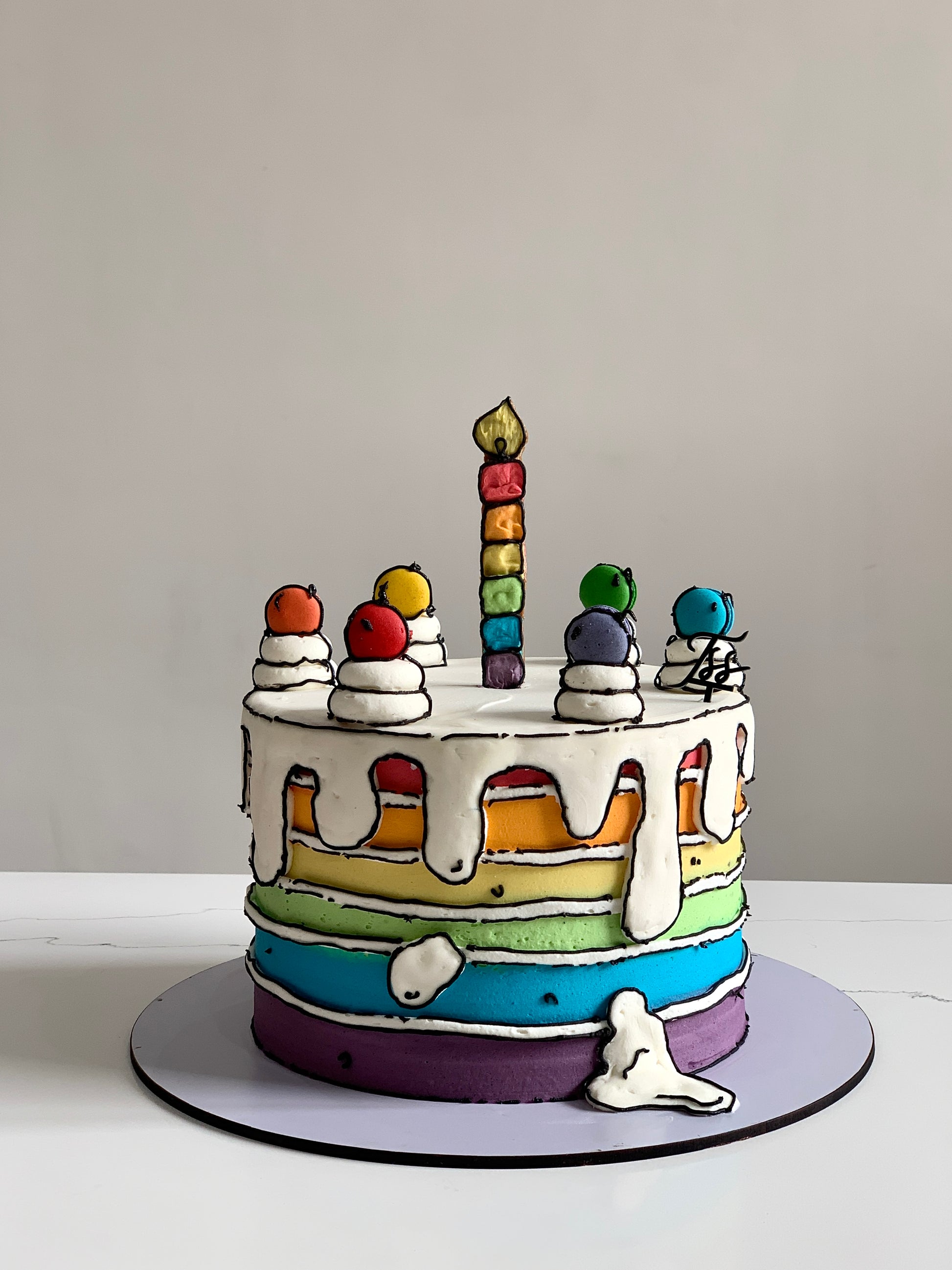 Colorful comic cake decorated with vibrant icing and fun cartoon-themed toppers from The Sinful Spoon.