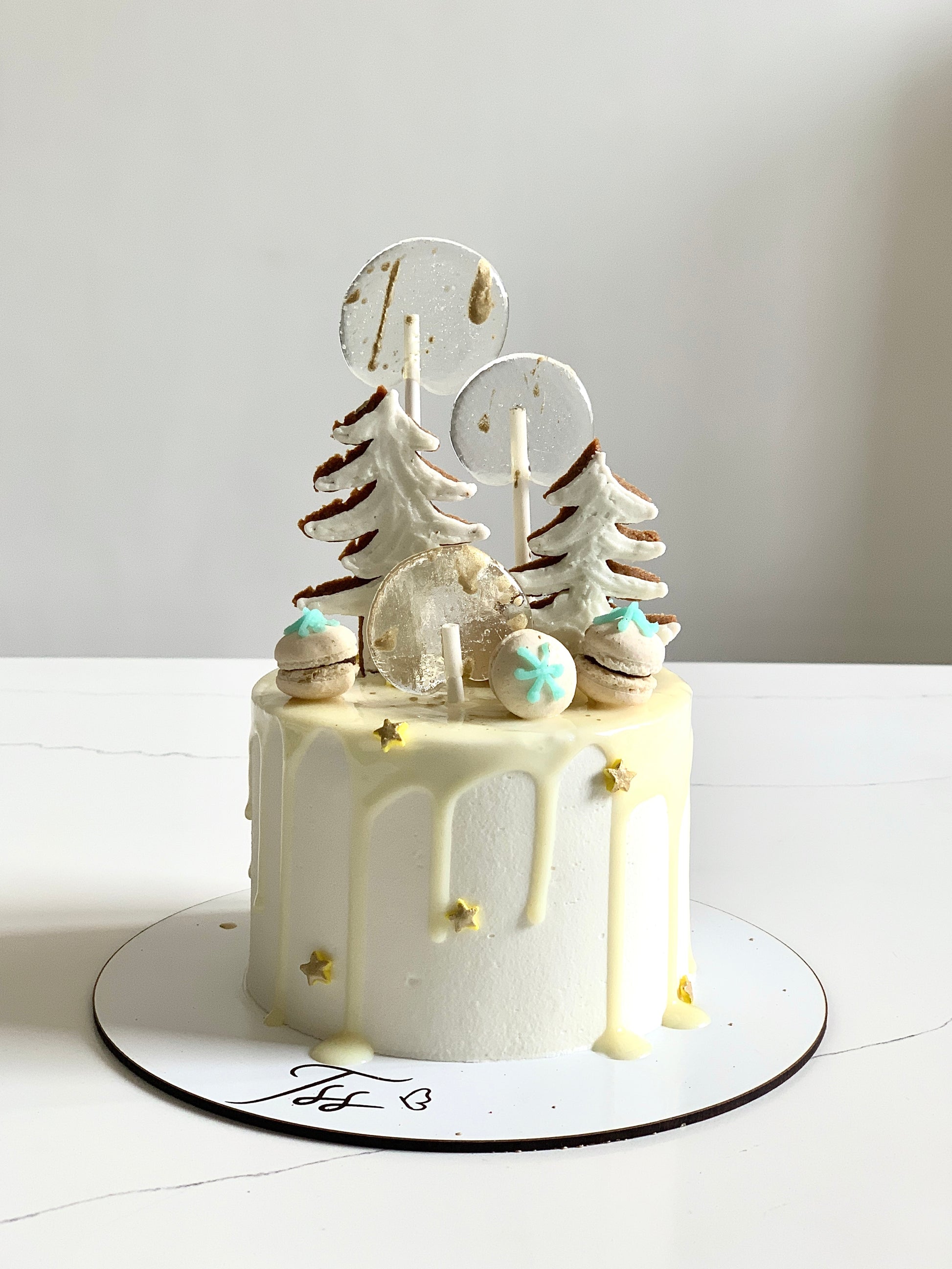 Decorative Christmas cakes from The Sinful Spoon featuring festive icing, colorful toppings, and holiday-themed designs.