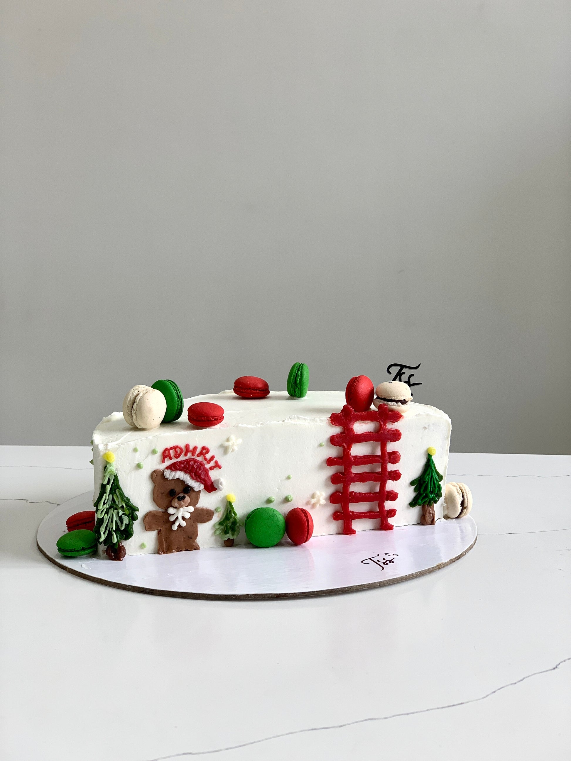Decorative Christmas cake from The Sinful Spoon with festive icing and holiday-themed toppings.