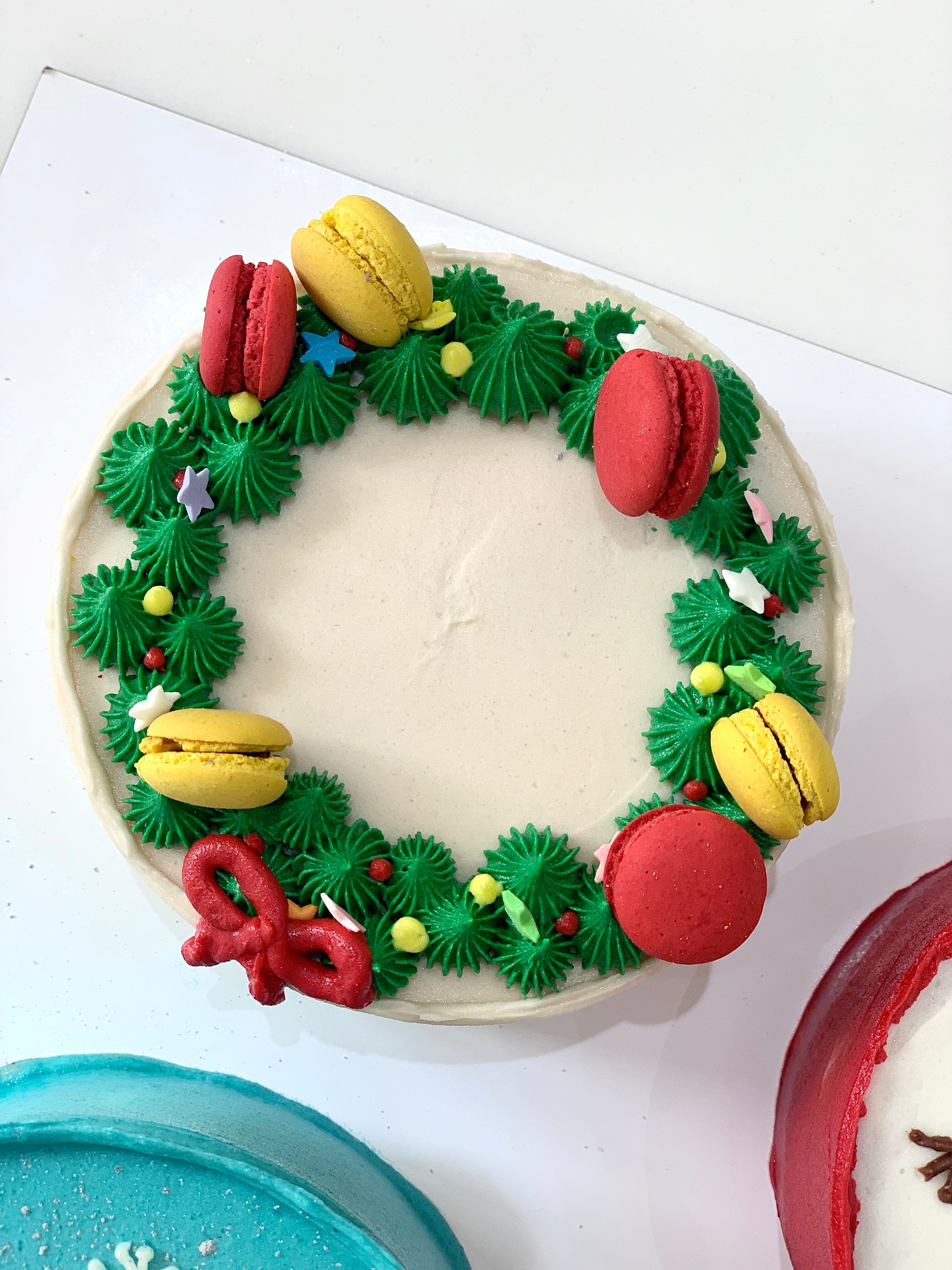 Decorative Christmas cake from The Sinful Spoon featuring festive icing and holiday-themed decorations.
