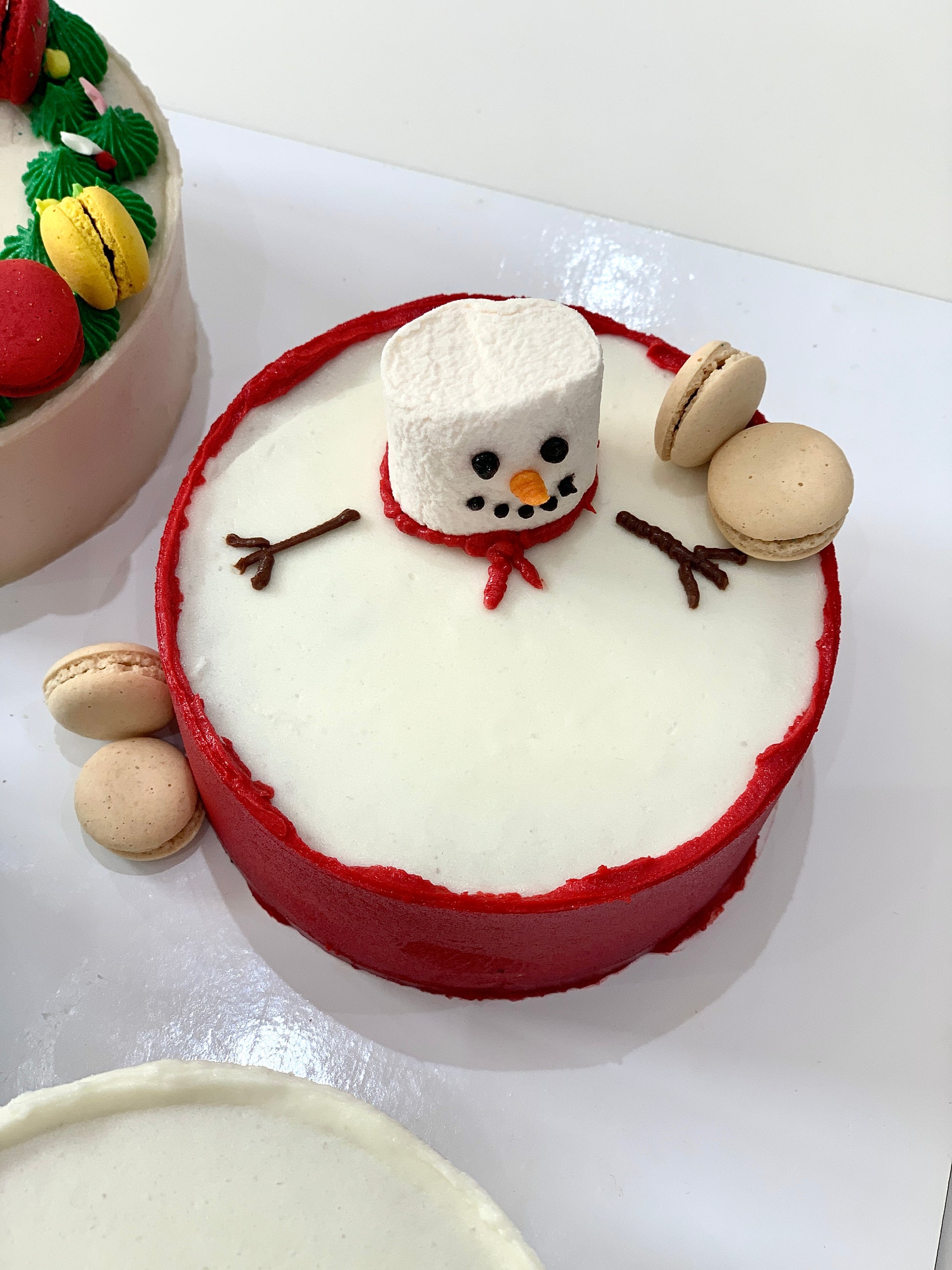 Decorative Christmas cake from The Sinful Spoon featuring festive icing, colorful toppings, and holiday-themed design.