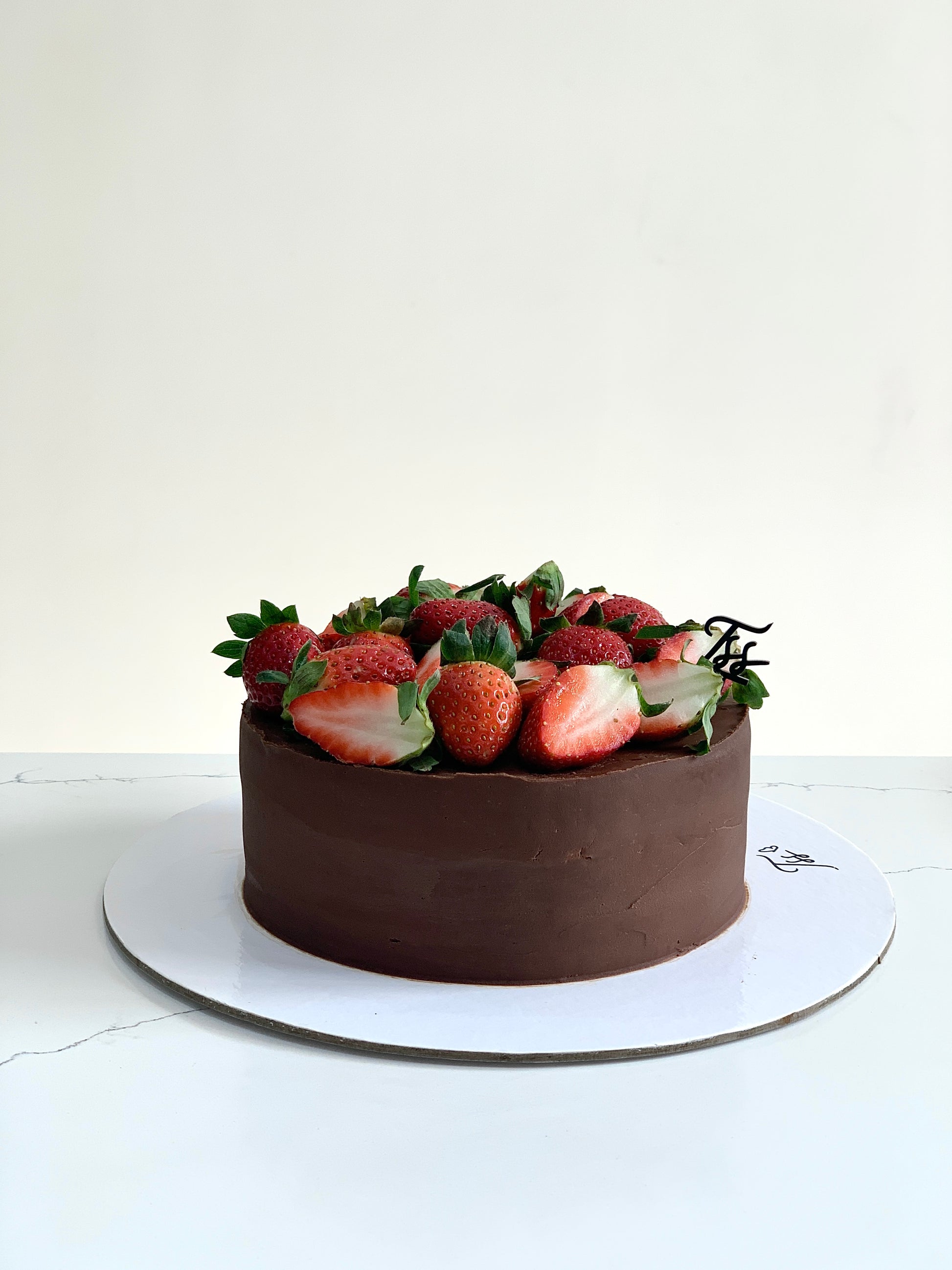 Fresh fruit cakes from The Sinful Spoon displayed on a plate, featuring vibrant fruit toppings and moist cake texture.
