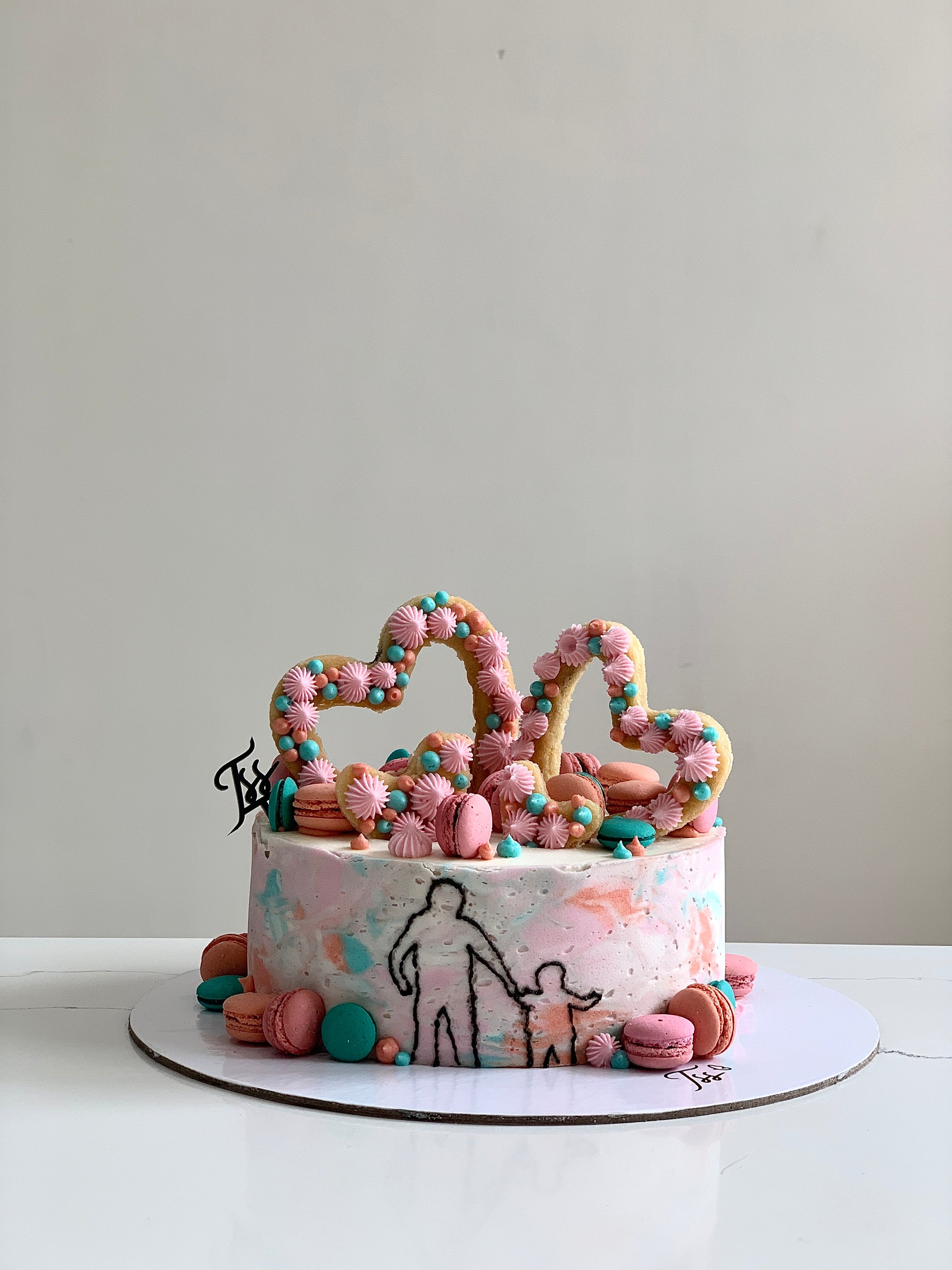 Valentine's Day cake from The Sinful Spoon with red and pink frosting, decorated with hearts and romantic accents.