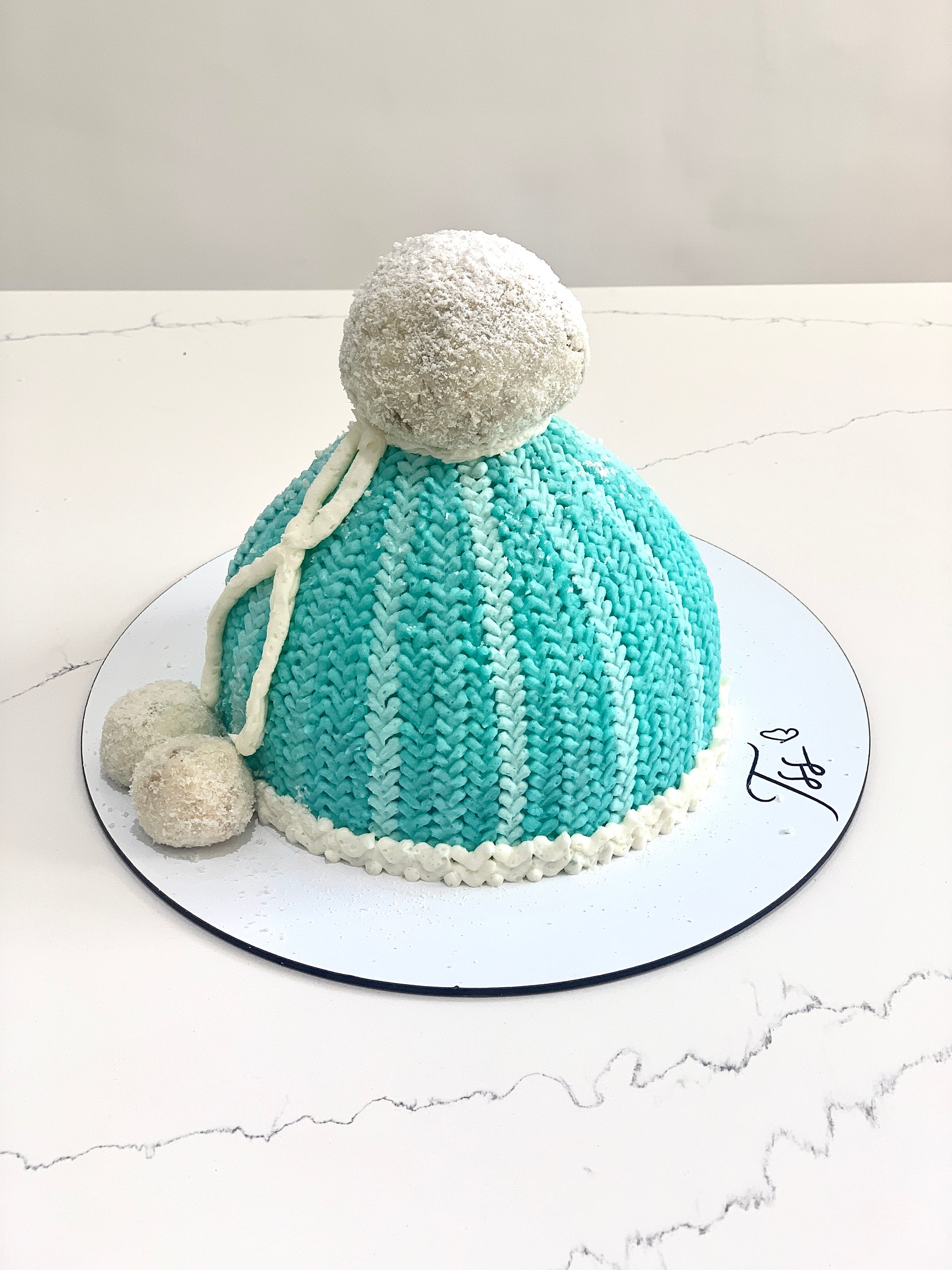 Decorative Christmas cake from The Sinful Spoon with festive icing and holiday-themed toppings, perfect for holiday celebrations.