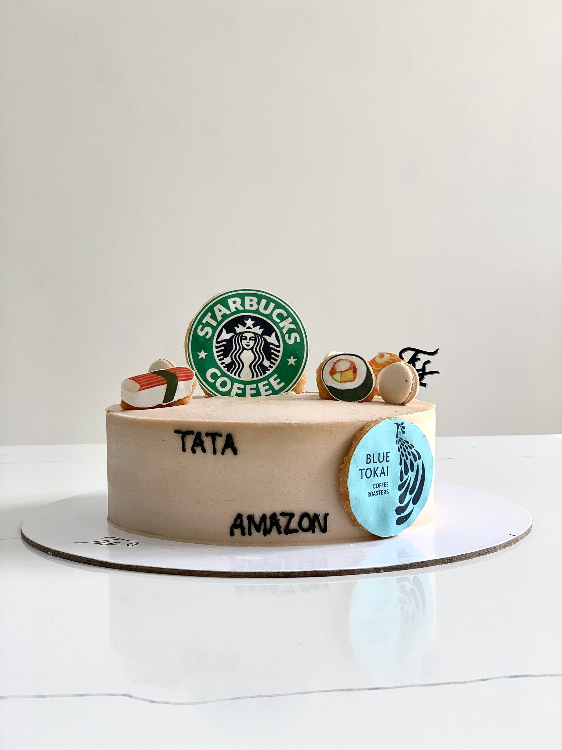 Edible paper cakes by The Sinful Spoon featuring colorful, decorative cake designs on a white background.