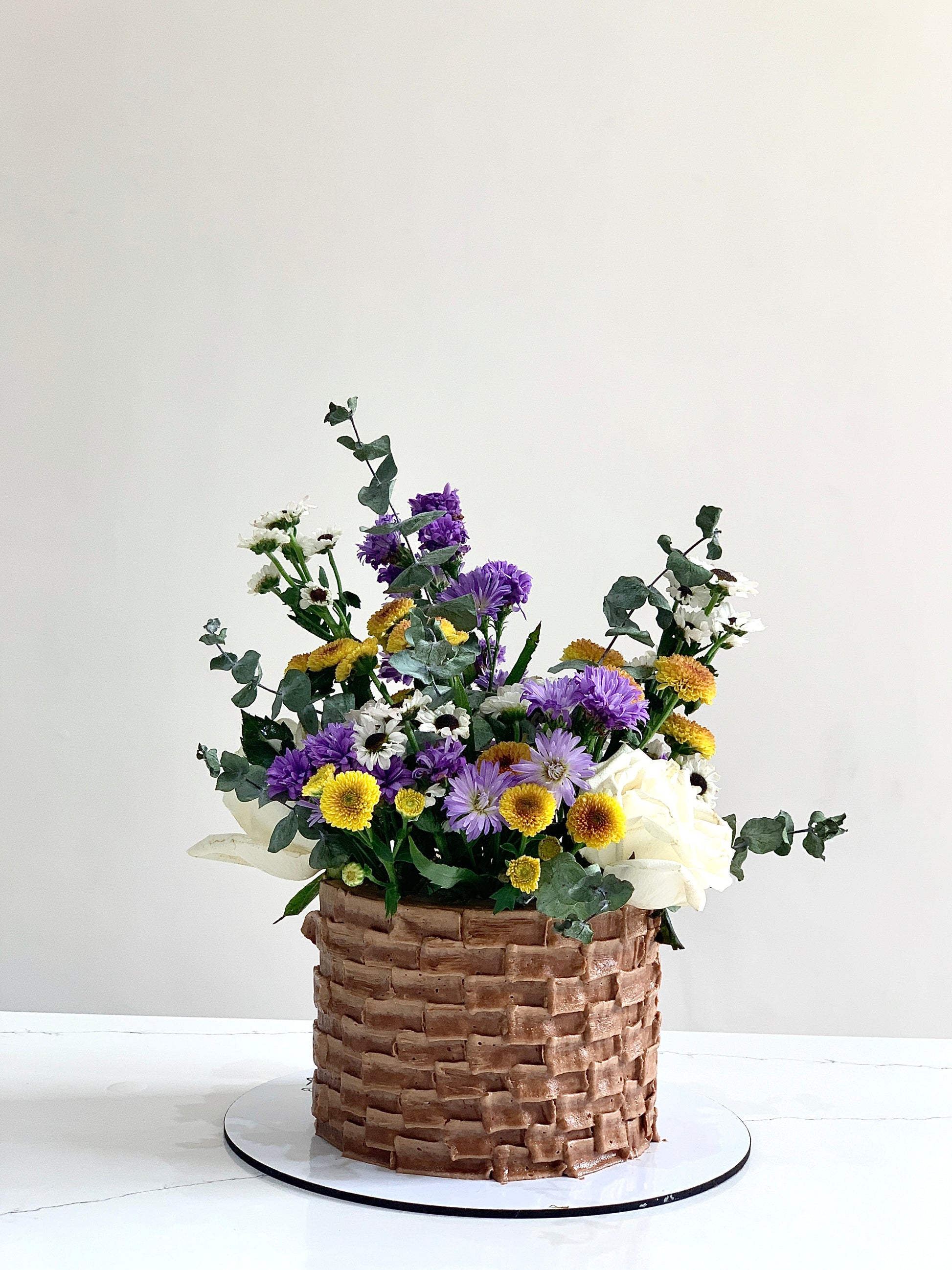 Fresh floral cakes by The Sinful Spoon featuring colorful, intricately decorated cakes with fresh flowers and elegant designs.