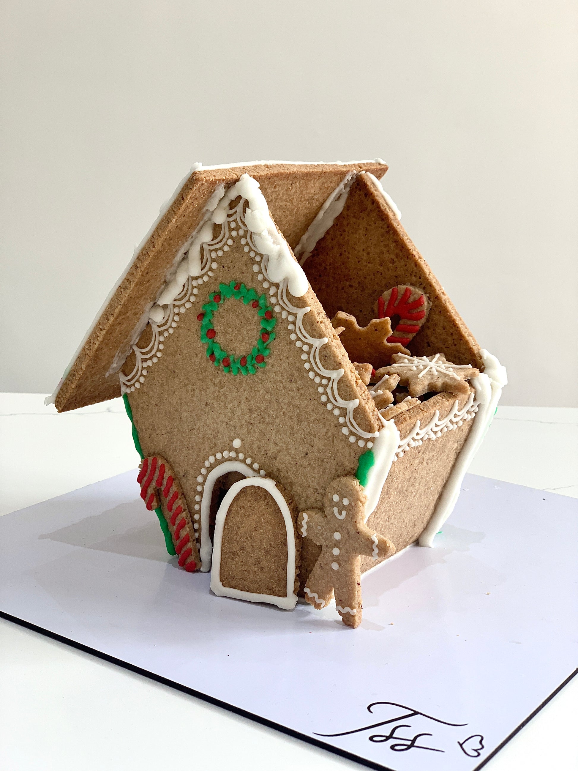 Decorative Christmas cake from The Sinful Spoon featuring festive icing and holiday-themed decorations.