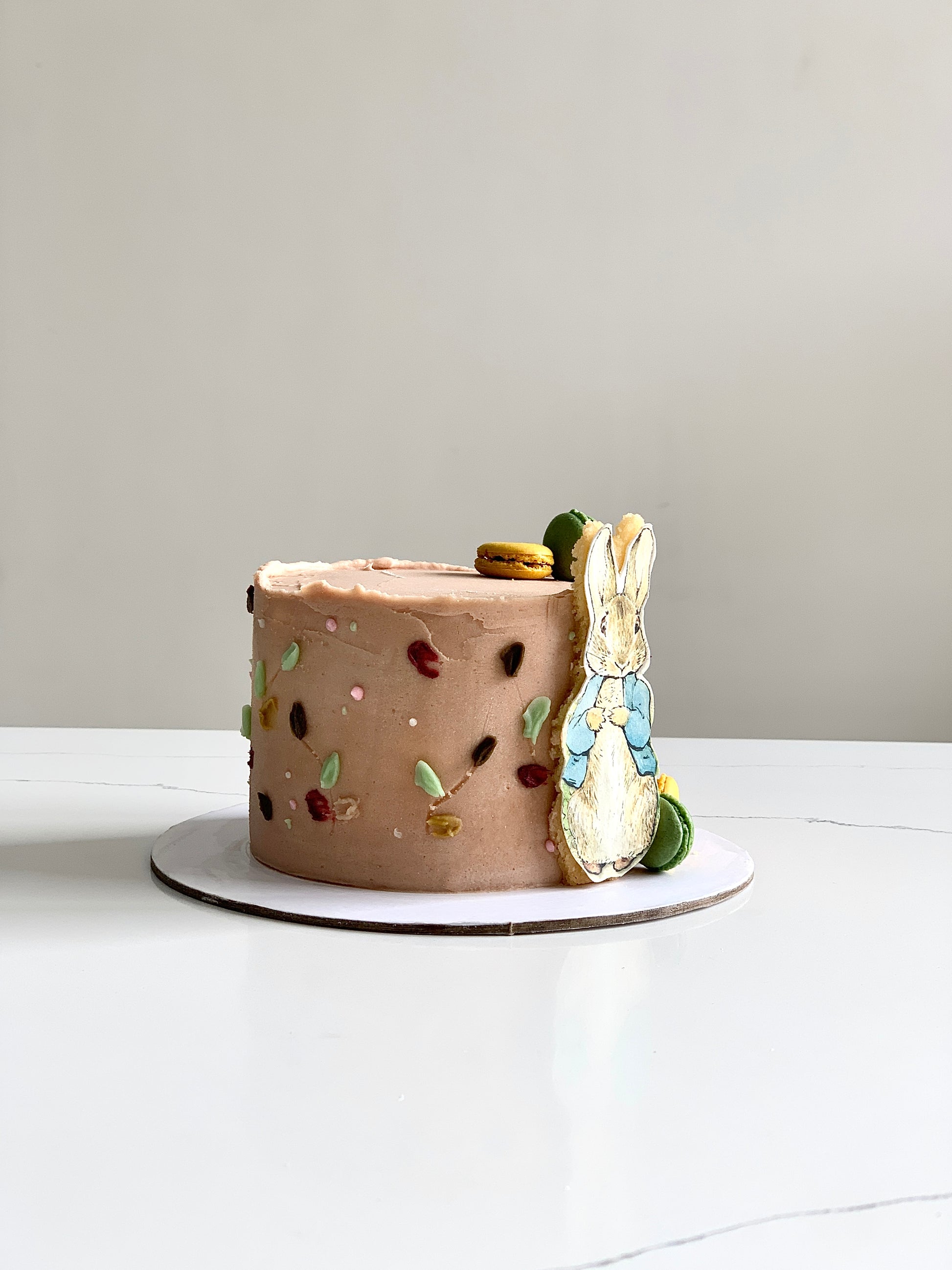 Edible paper cake with baby boy design from The Sinful Spoon, decorated with blue and white icing for celebration.