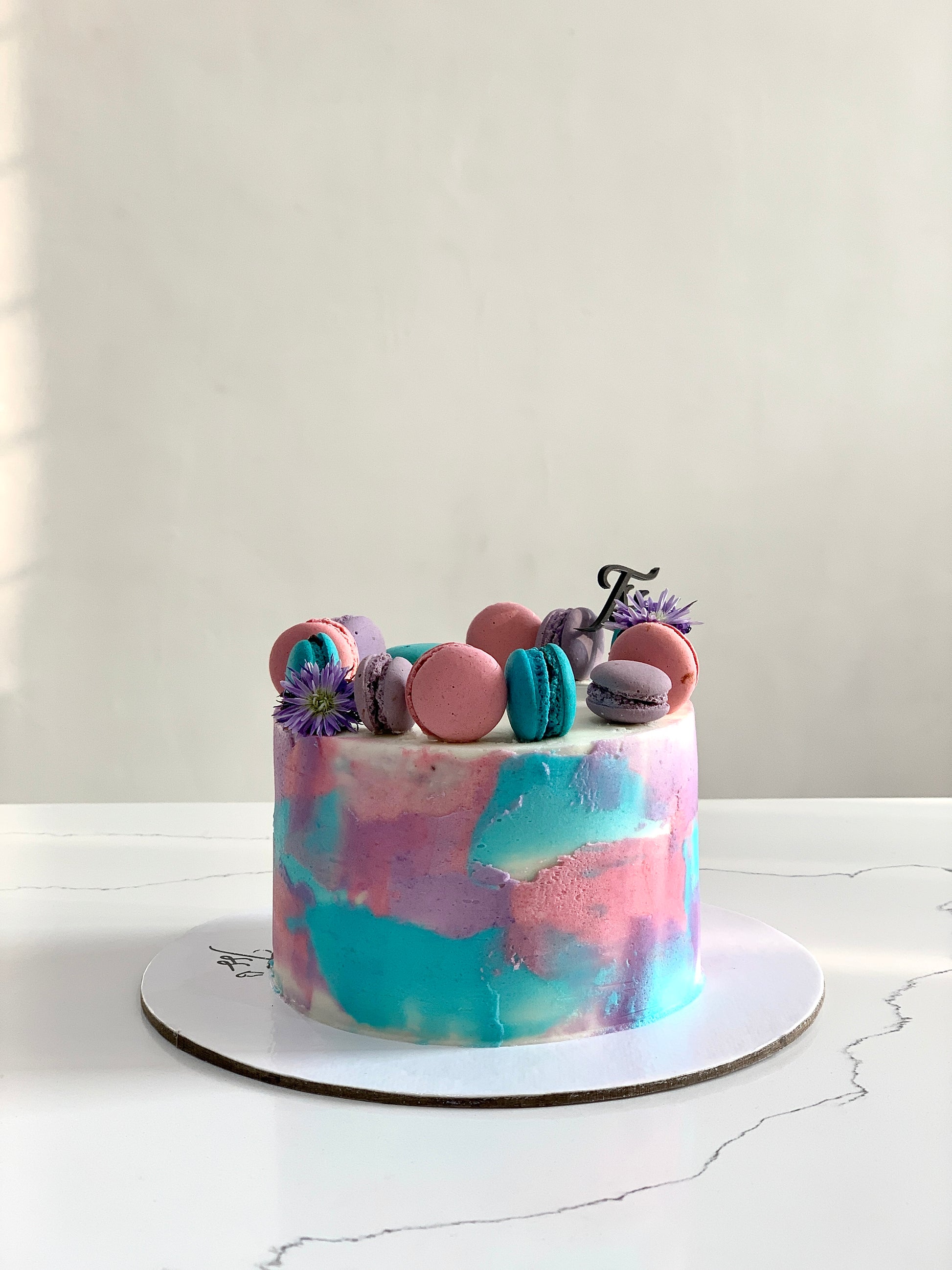Classic Cakes from The Sinful Spoon, featuring a variety of decorated cakes with colorful frosting and intricate designs.