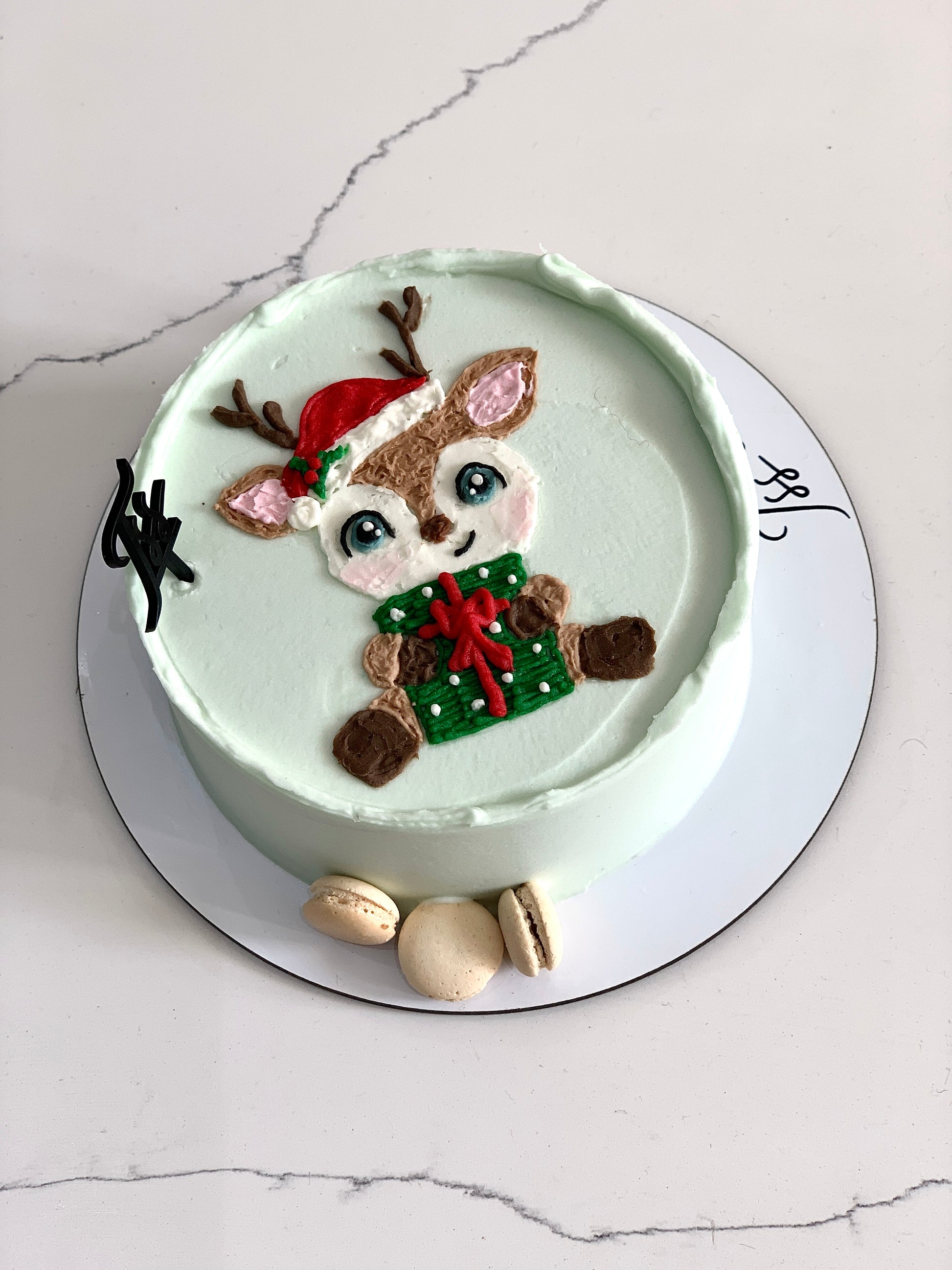 Decorative Christmas cakes from The Sinful Spoon with festive icing, colorful toppings, and holiday-themed designs.