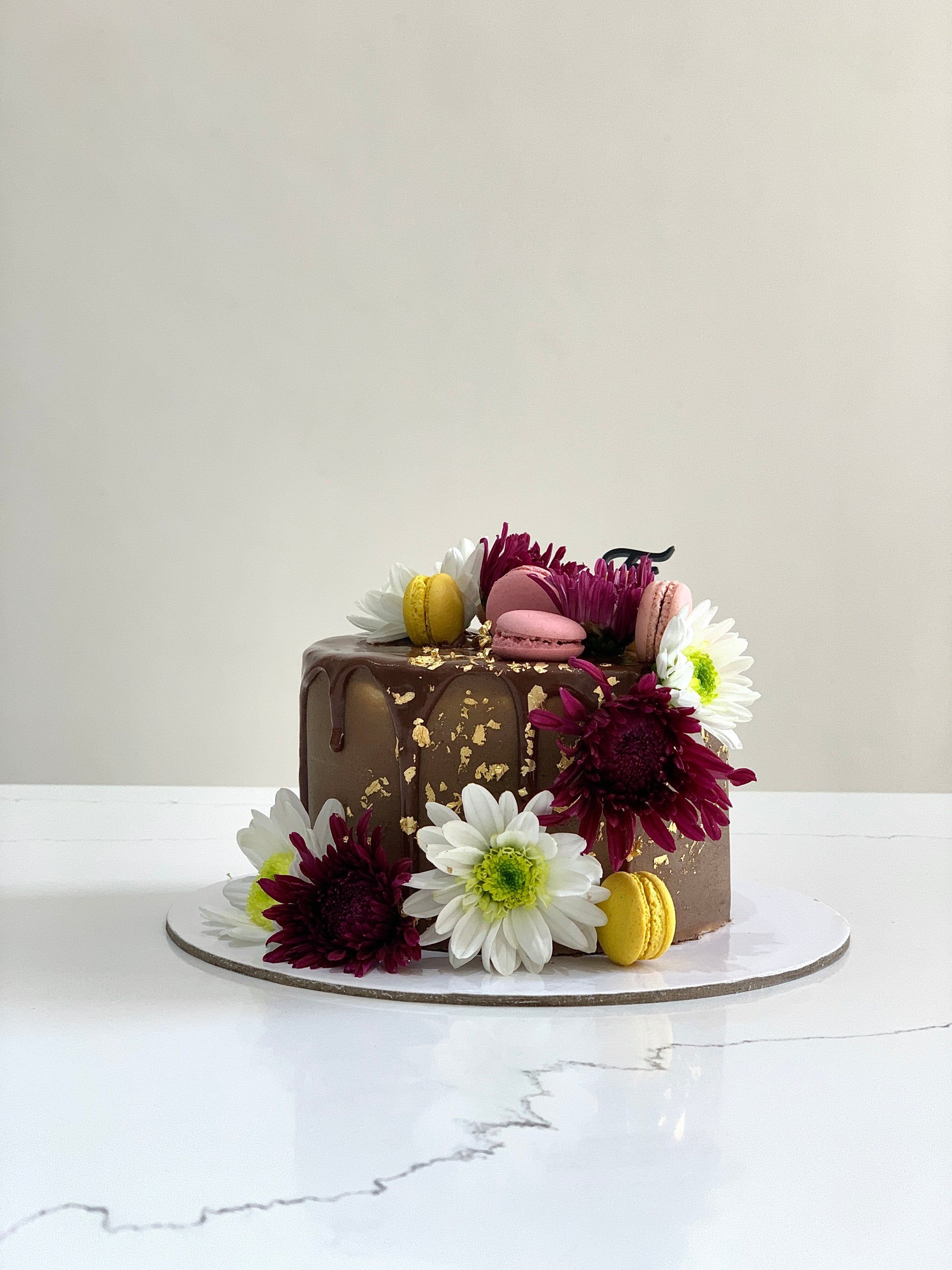Fresh floral cakes with colorful buttercream flowers from The Sinful Spoon, showcasing intricate floral piping and decorative details.