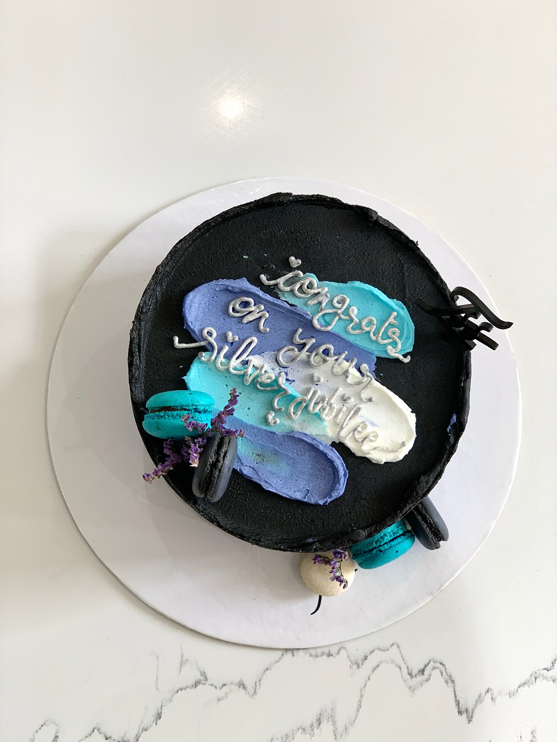 Mini bento cake from The Sinful Spoon with colorful frosting and decorative toppings, perfect for celebrations.