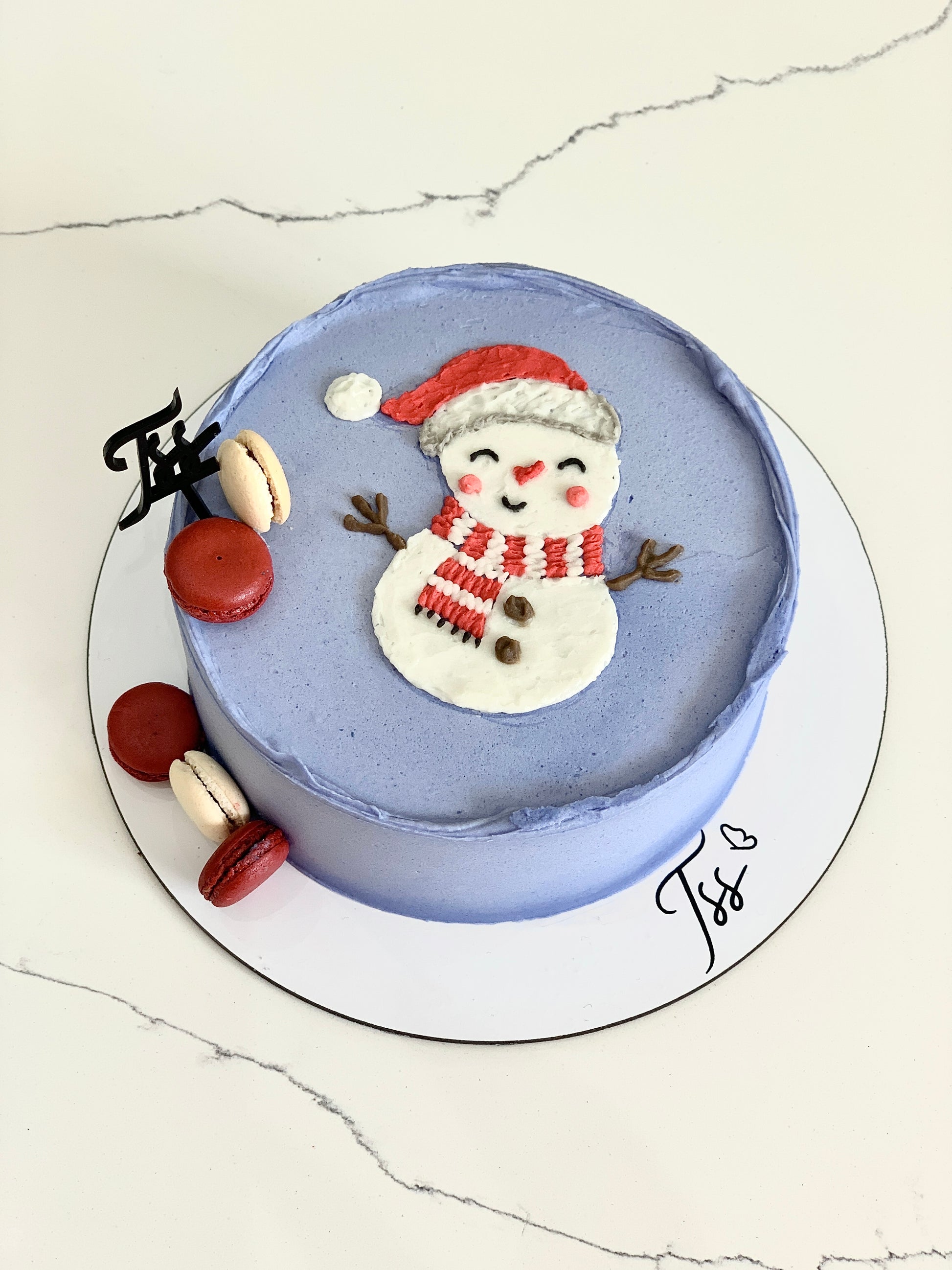 Decorative Christmas cakes from The Sinful Spoon with colorful icing and festive toppings, perfect for holiday celebrations.