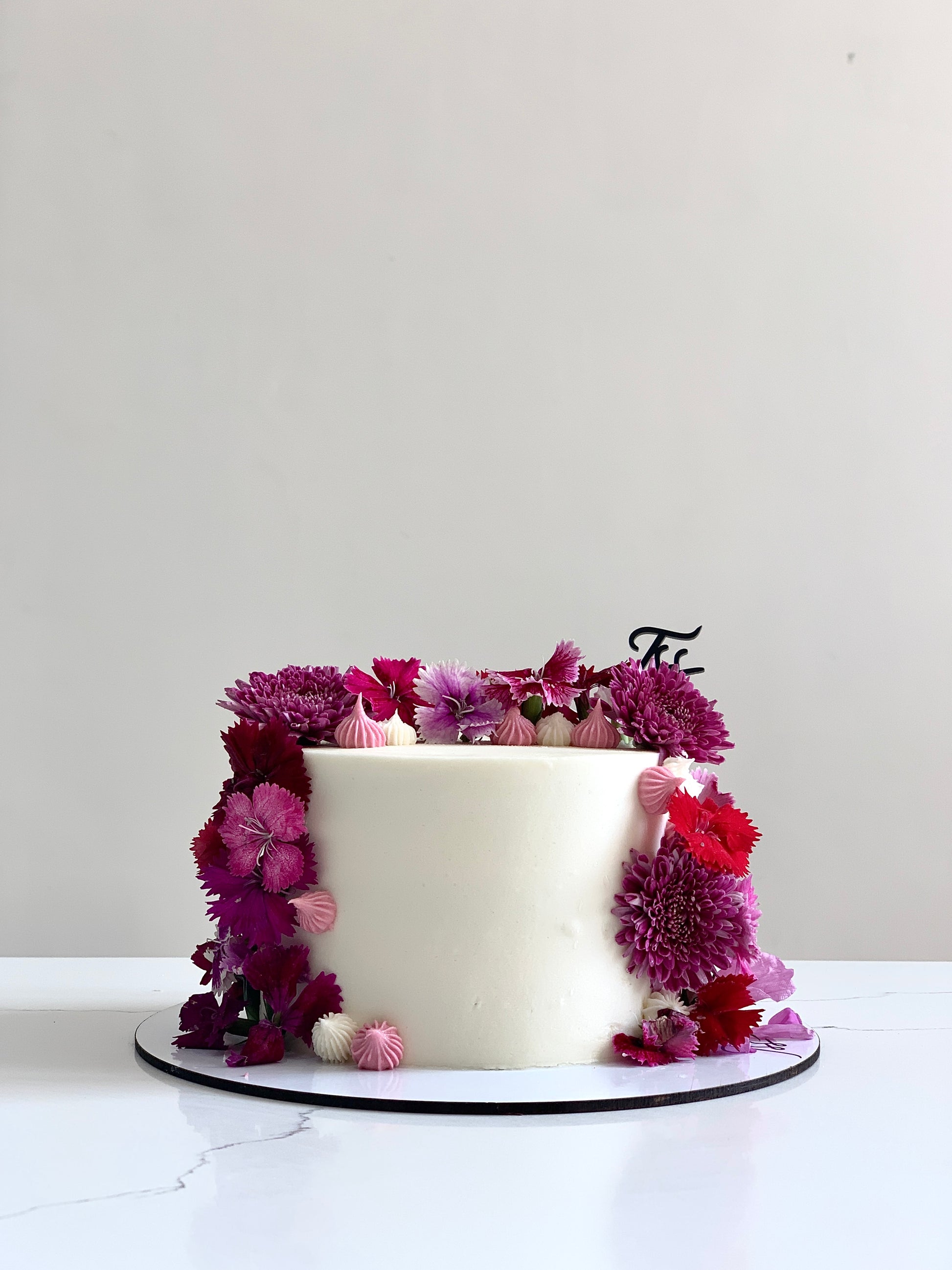 Fresh floral cakes from The Sinful Spoon featuring beautifully decorated cakes with fresh flowers and intricate designs.