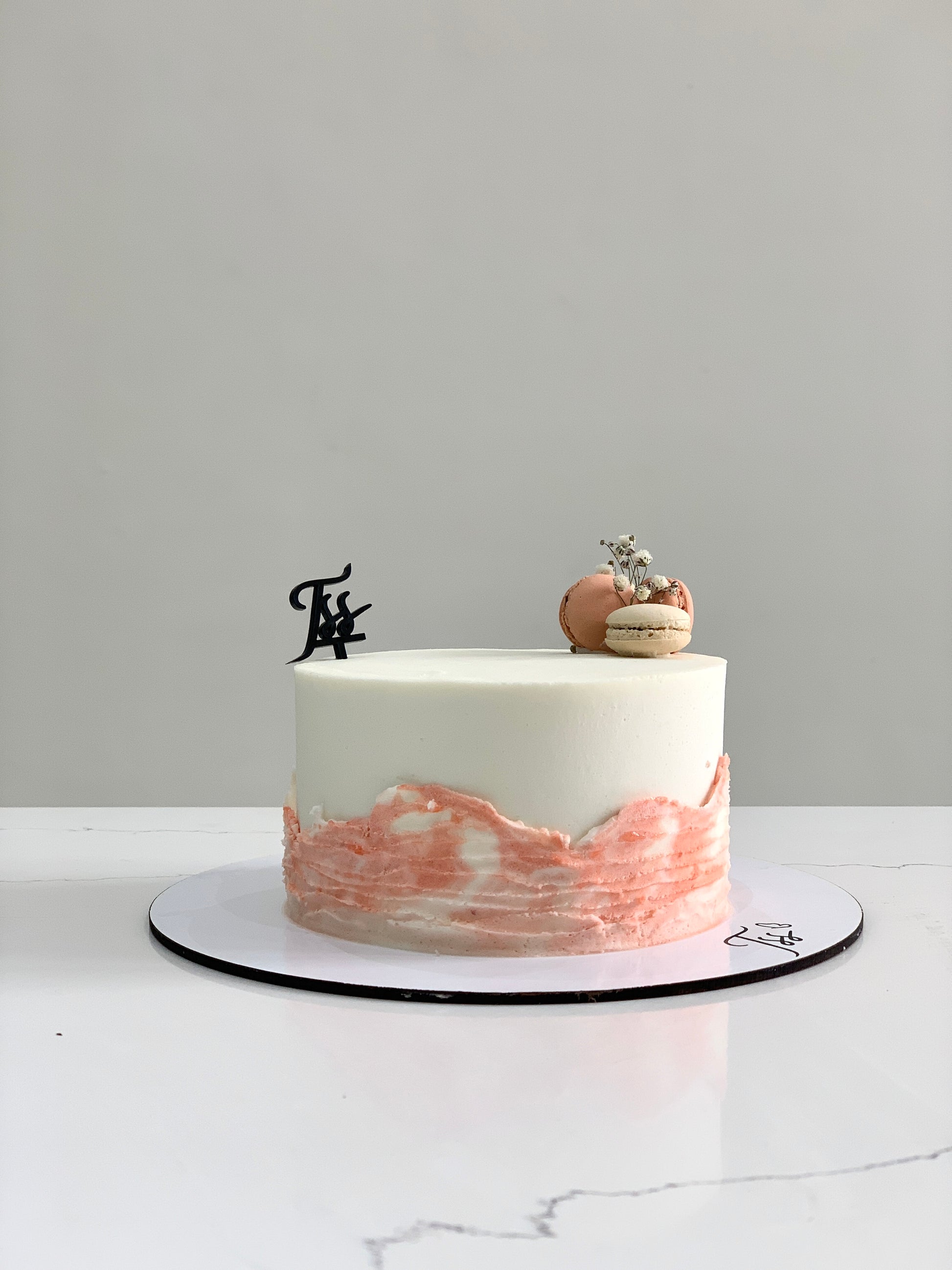 Classic cakes from The Sinful Spoon displayed on a plate with decorative sprinkles and frosting details.