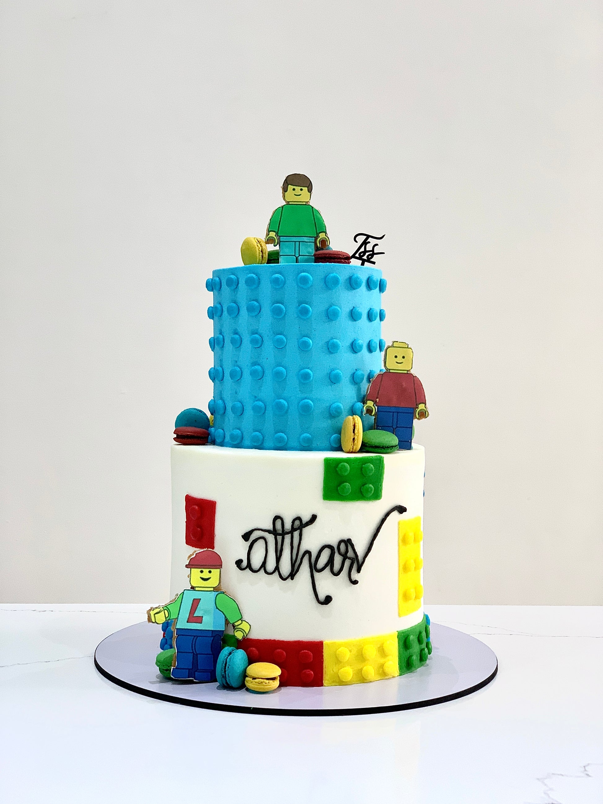 Colorful tiered kids' cake from The Sinful Spoon, decorated with vibrant frosting and playful designs for children's celebrations.