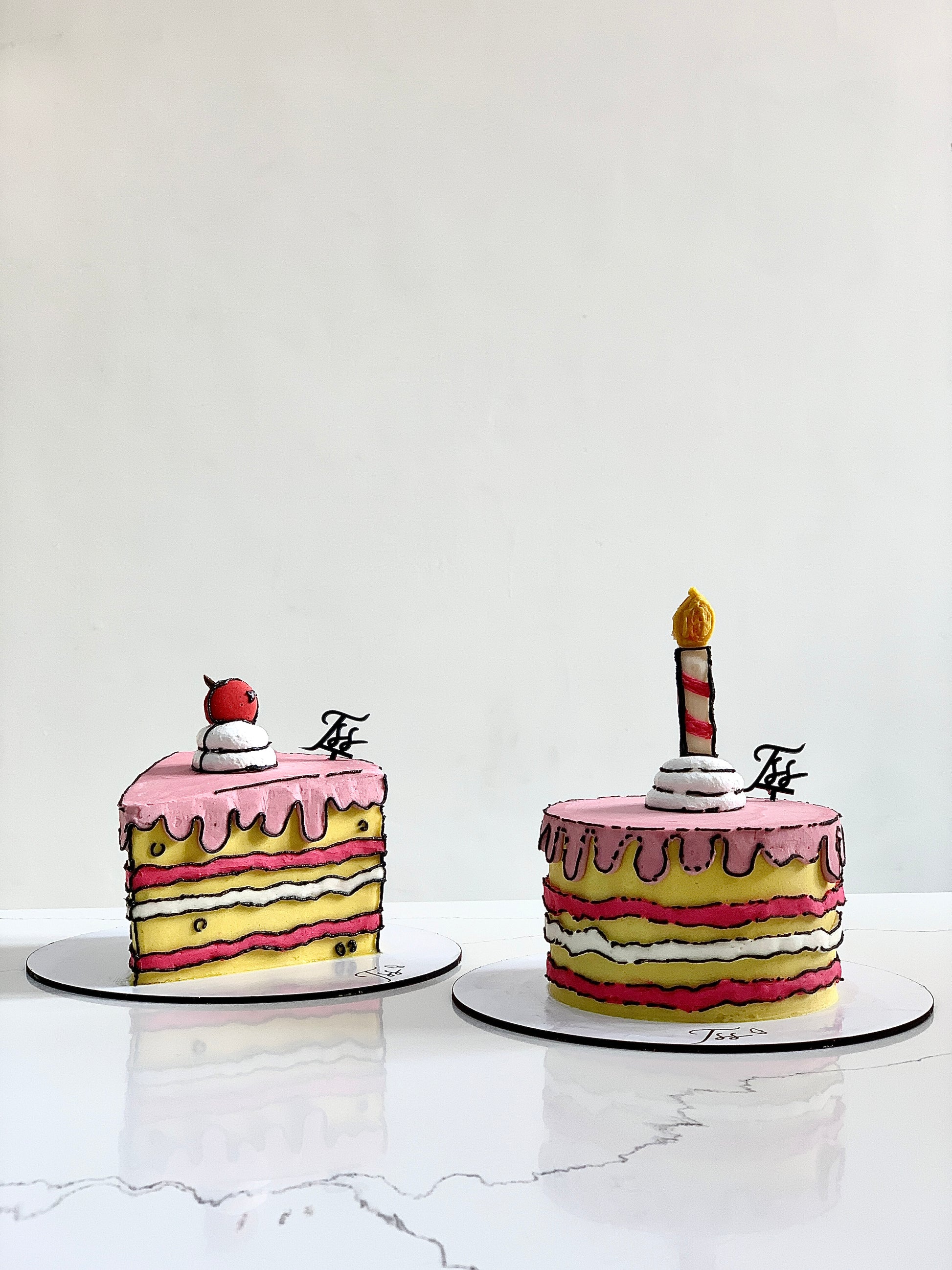 Colorful comic-themed cakes from The Sinful Spoon, decorated with vibrant icing and fun comic book designs.