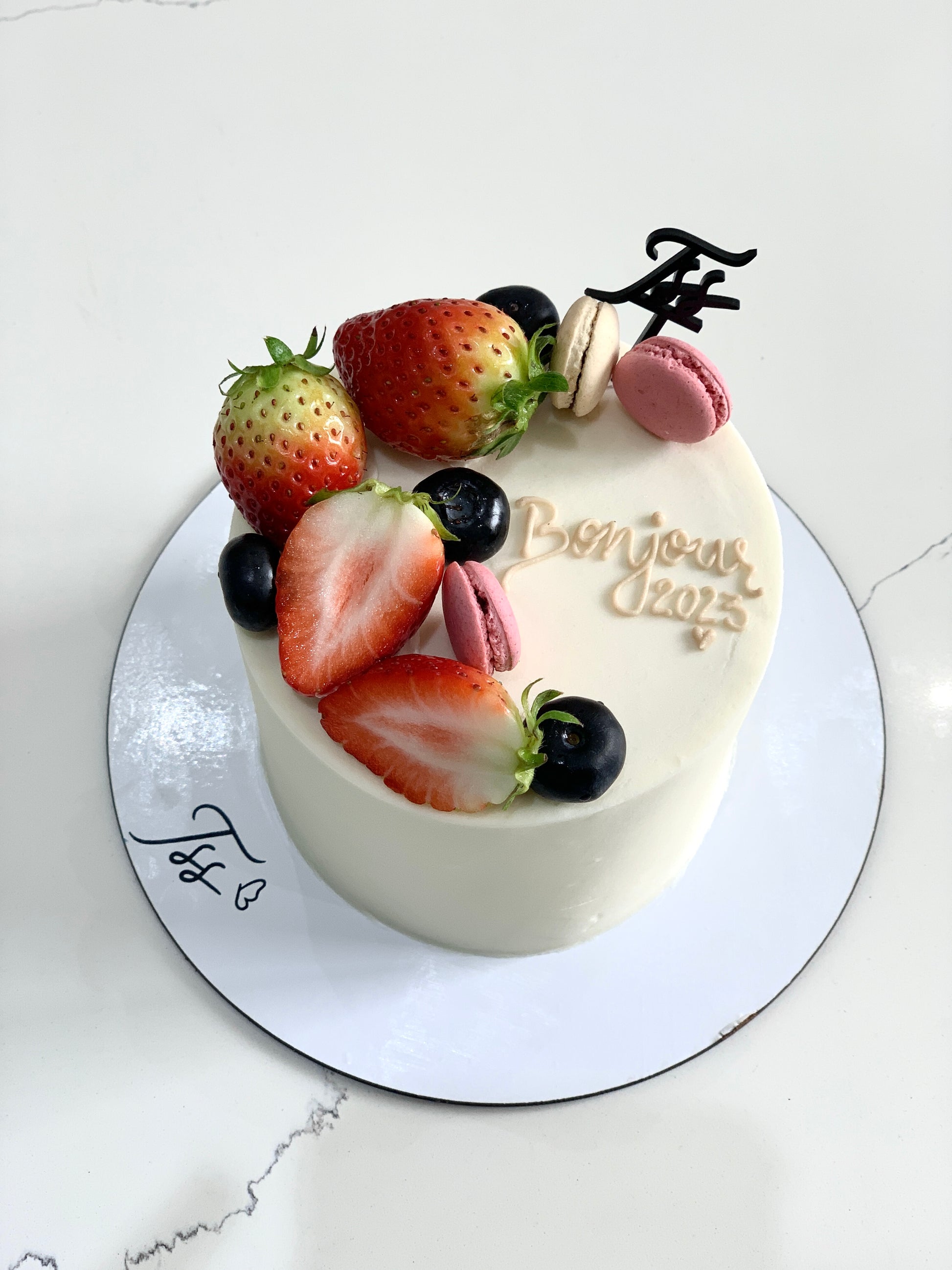 Fresh fruit cakes from The Sinful Spoon featuring colorful layers with fruit toppings and a moist, inviting texture.