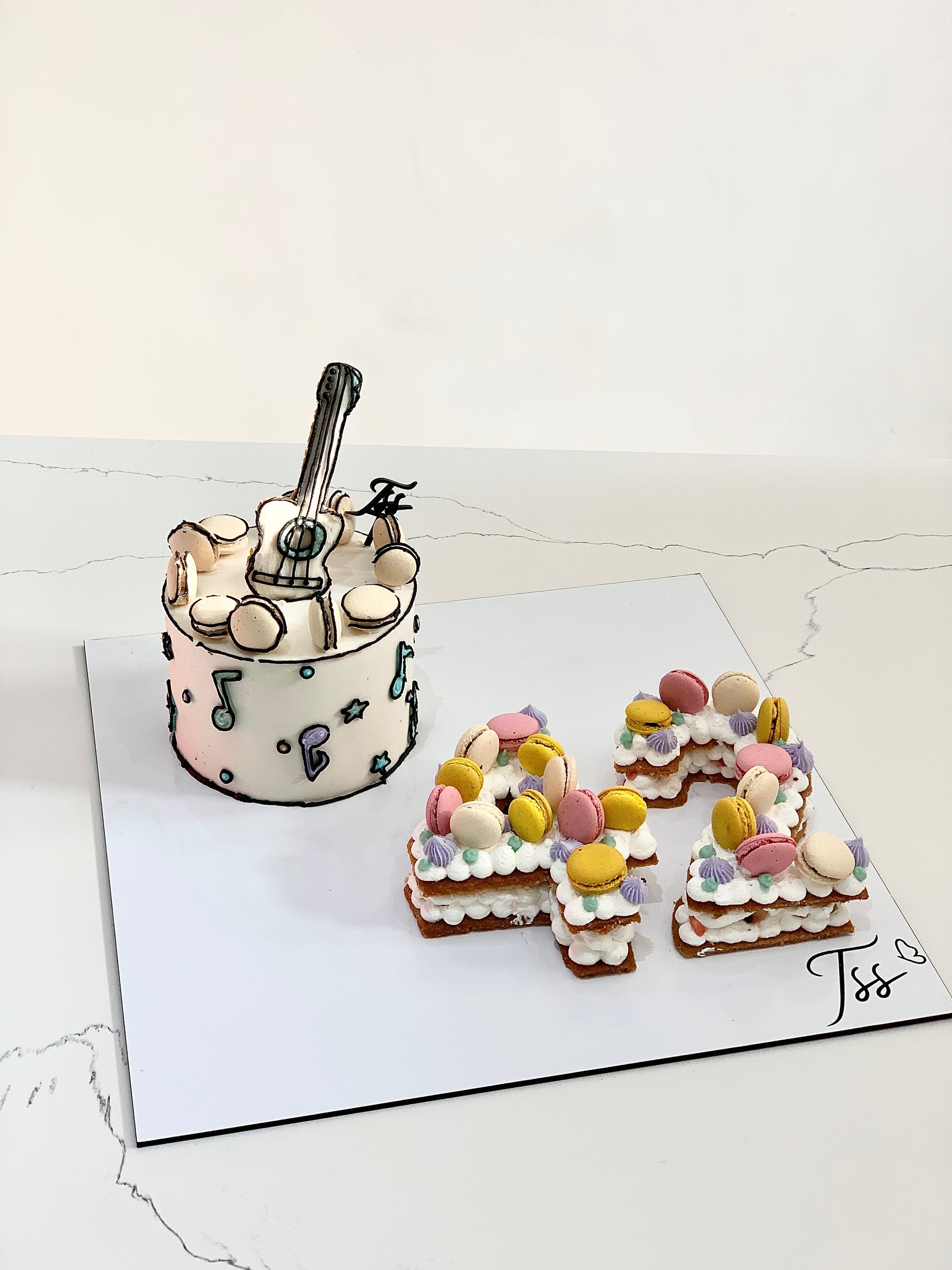 Assorted combo cakes from The Sinful Spoon, featuring colorful layered and decorated desserts on a white plate.