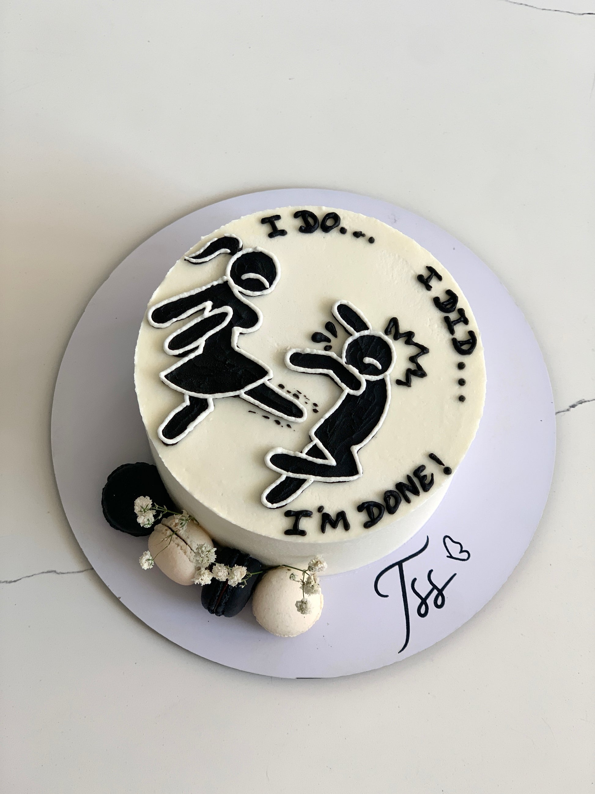 Buttercream illustration cake by The Sinful Spoon with colorful floral designs and intricate piping details on a white background.