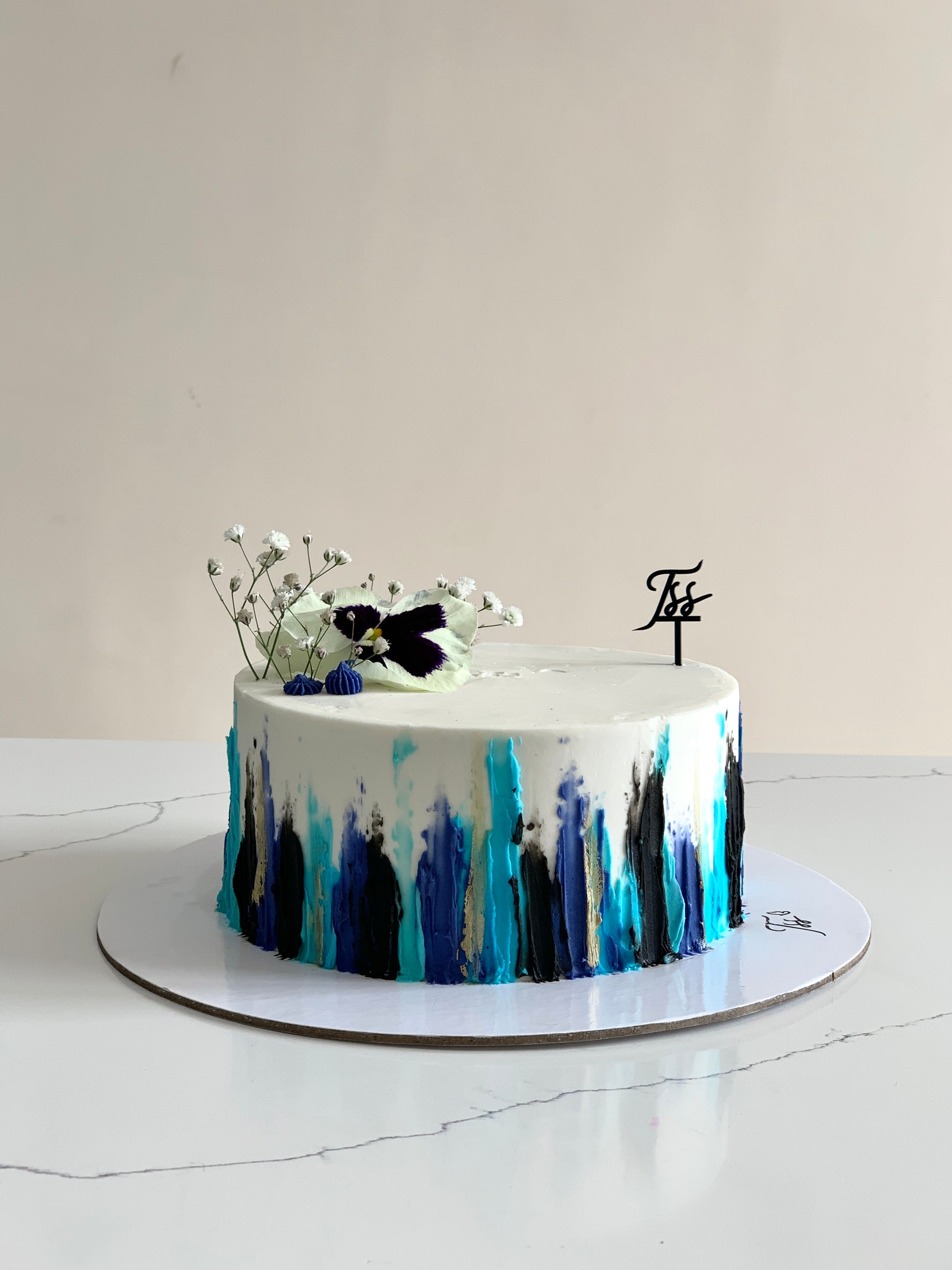 Classic cakes from The Sinful Spoon displayed on a plate with various colorful frosting and decorative toppings.