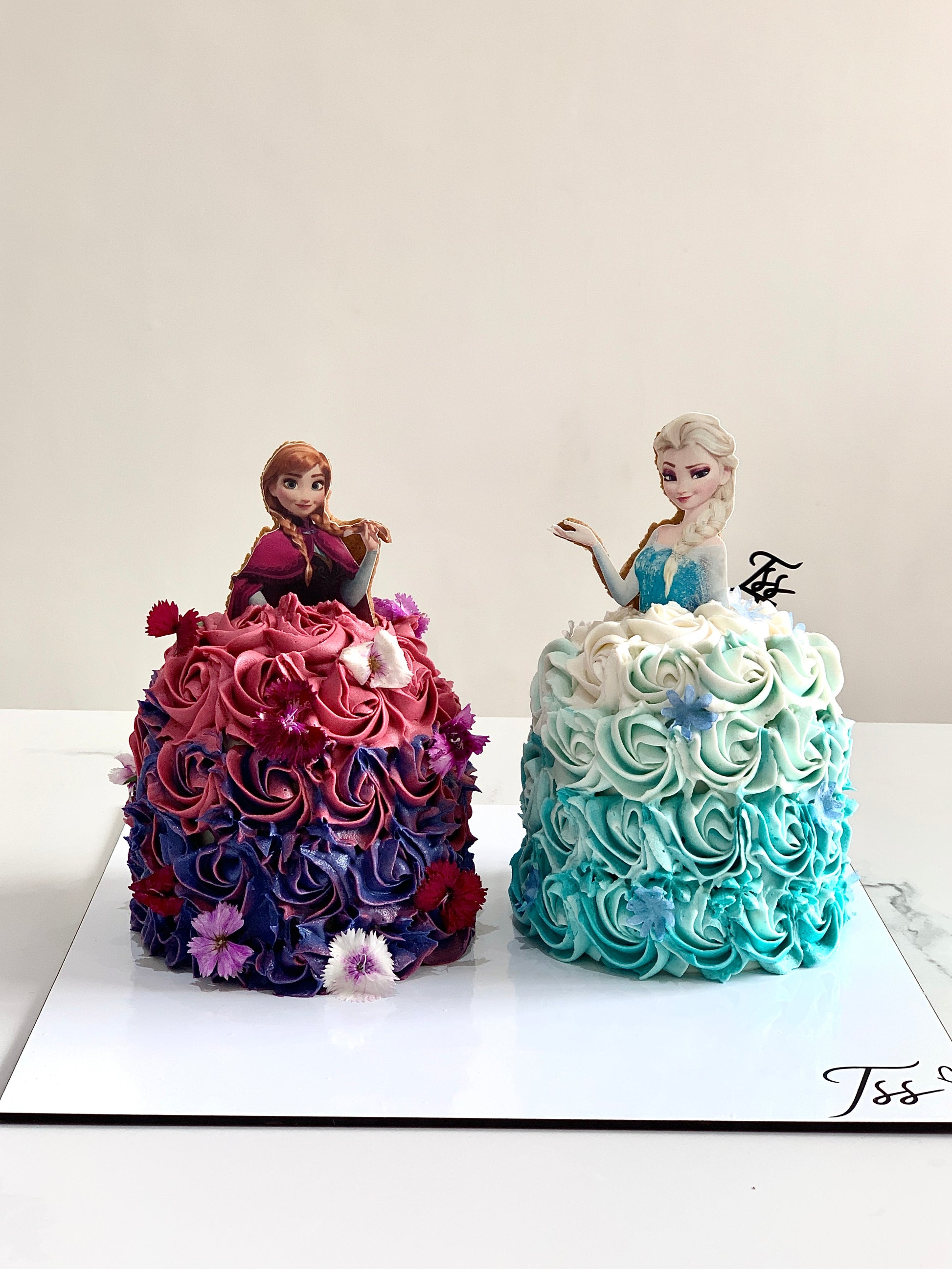 Edible paper cake featuring a baby girl design from The Sinful Spoon, decorated with colorful edible images and intricate details.