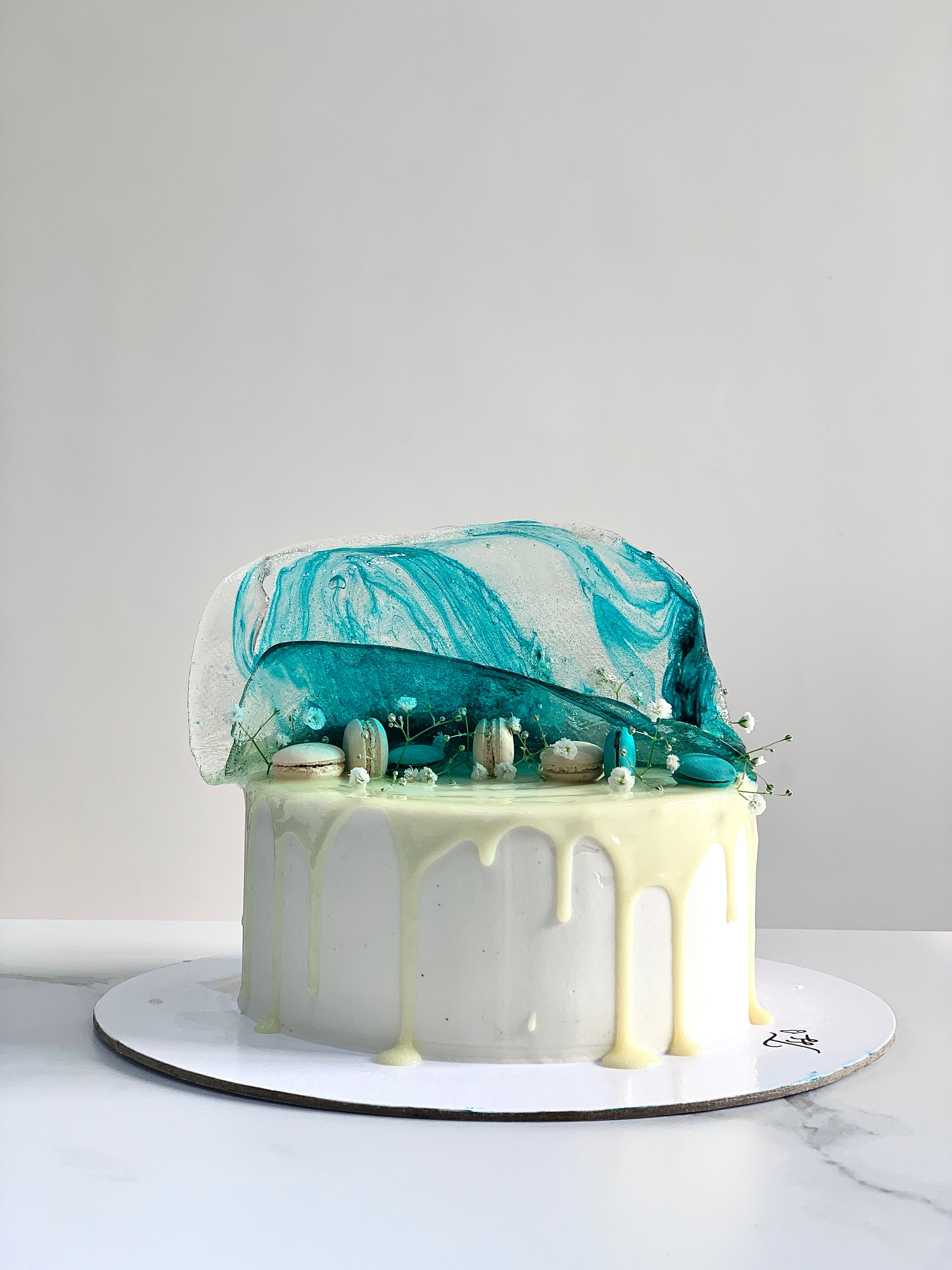Isomalt cakes from The Sinful Spoon, colorful sugar-based candies arranged in a decorative pattern on a white surface.