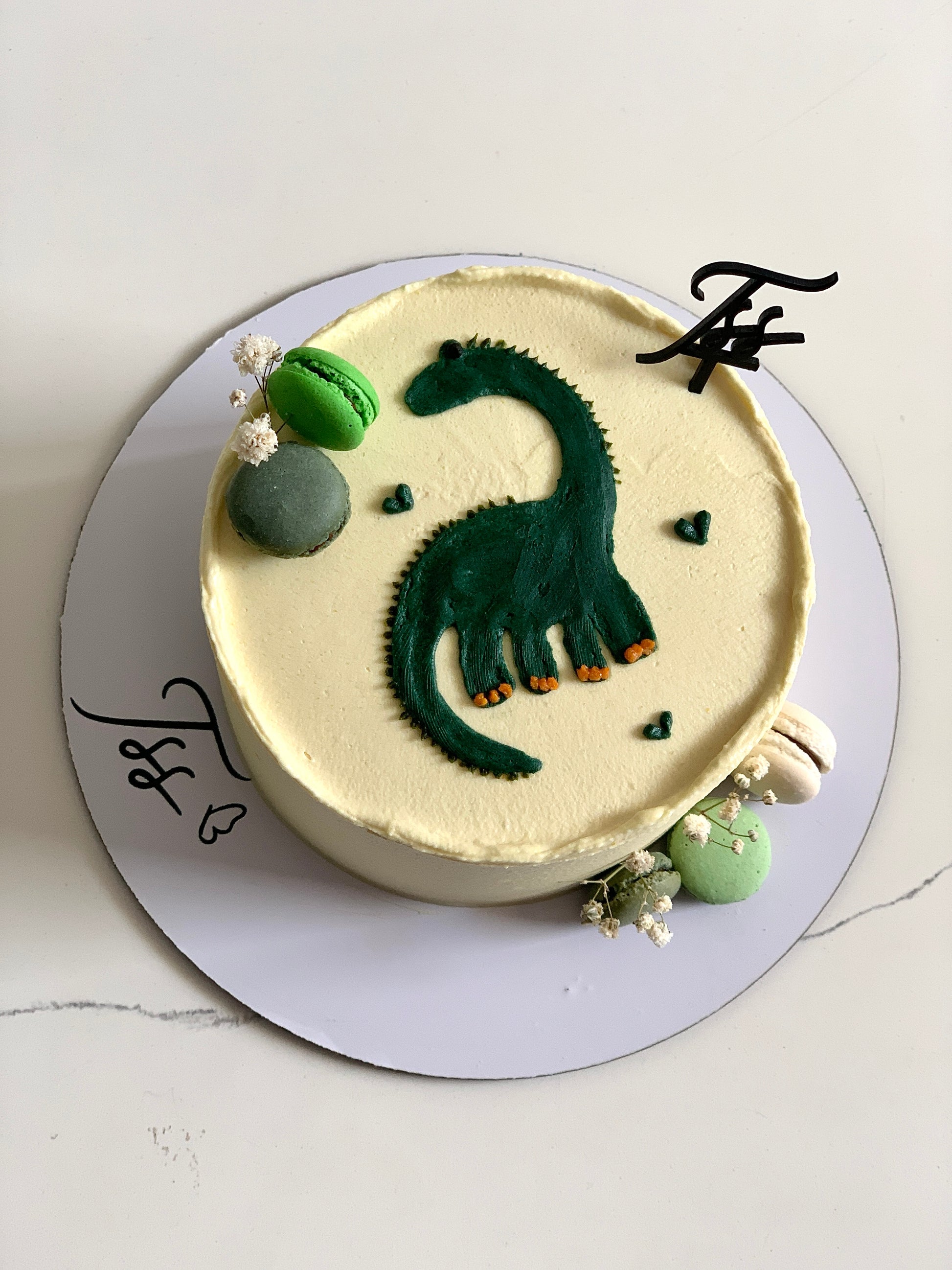 Colorful buttercream illustration cake from The Sinful Spoon with vibrant, artistic piping and detailed decorative elements.