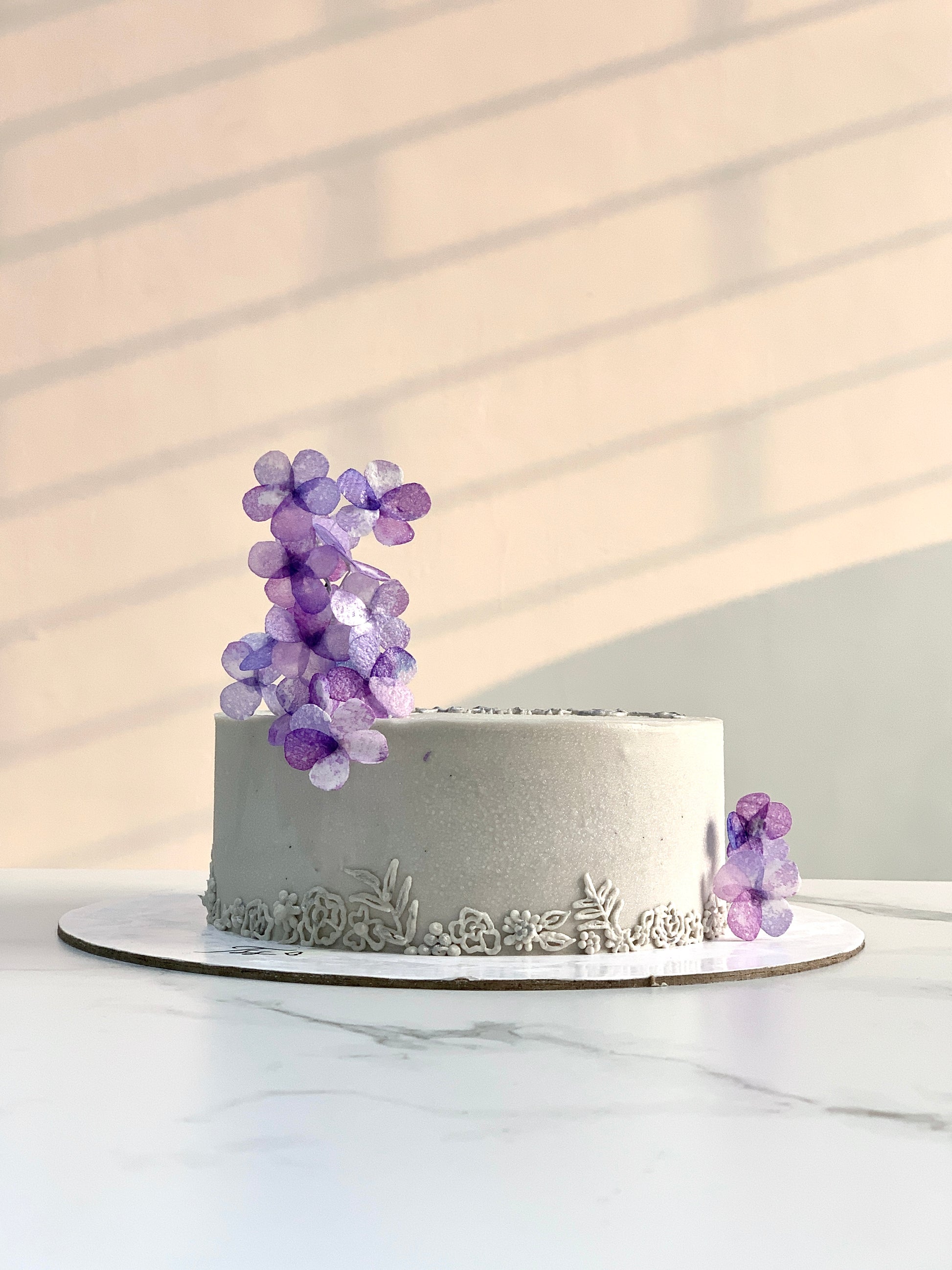 Decorative Mother's Day cake from The Sinful Spoon with floral icing and festive design, perfect for celebrating moms.