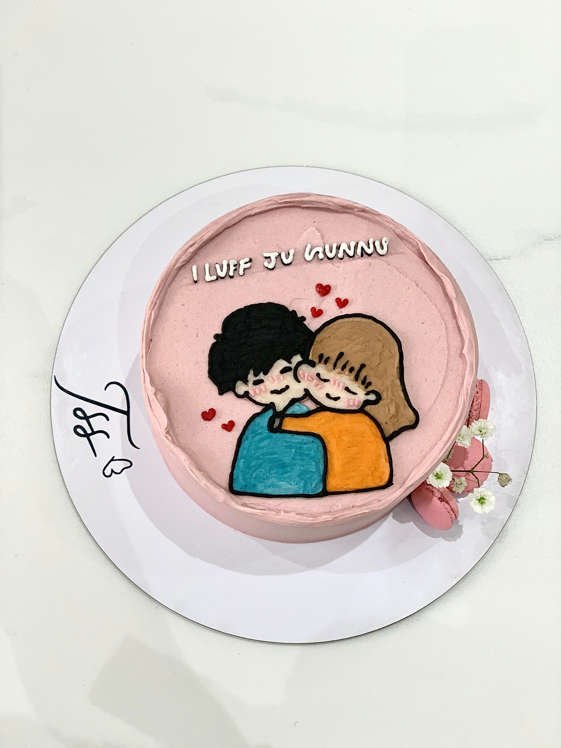 Valentine's Day cake from The Sinful Spoon with pink frosting, heart-shaped decorations, and festive Valentine's Day presentation.
