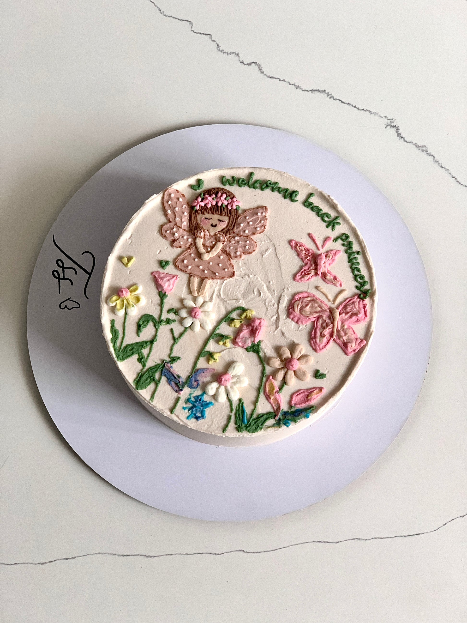 Buttercream Illustration Cake by The Sinful Spoon featuring colorful floral and whimsical designs on a layered cake.